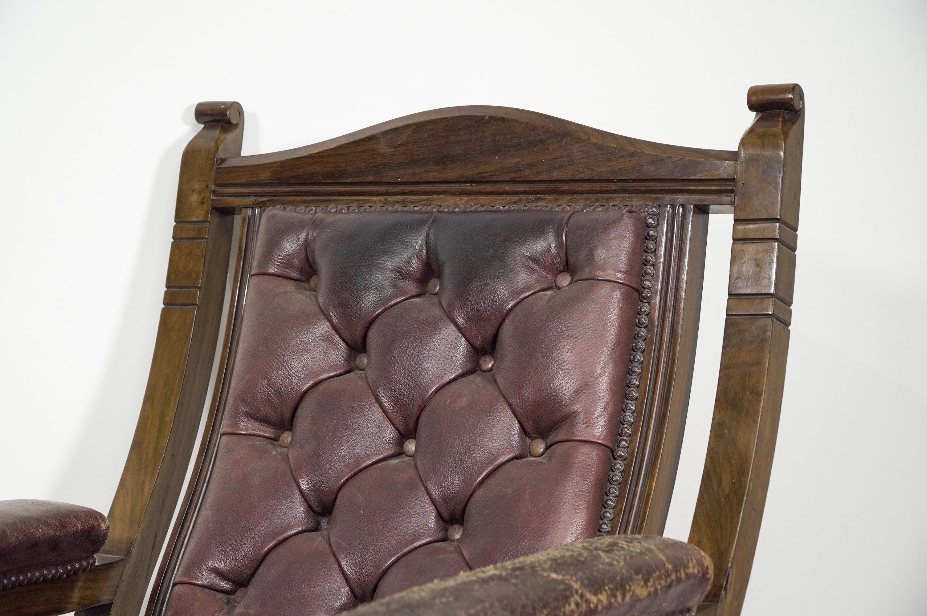 Walnut An Aesthetic Movement walnut armchair with a curvaceous back leather upholstery. For Sale
