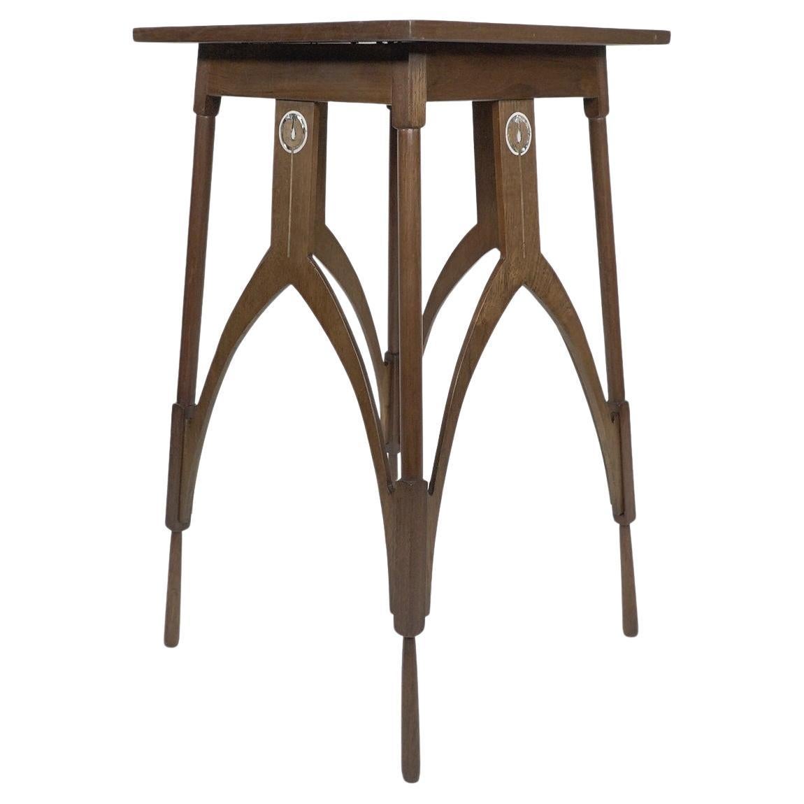 Baillie Scott style, A Walnut side table inlaid with Mother-of-Pearl decoration.