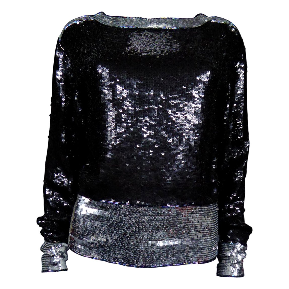 Circa 1980/1990
France
Top entirely embroidered with black and silver sequins by Yves Saint Laurent Rive Gauche dating from the 1980s. Round low-cut neckline, long sleeves and closure with two zips on the sides and snaps on the shoulders. Embroidery