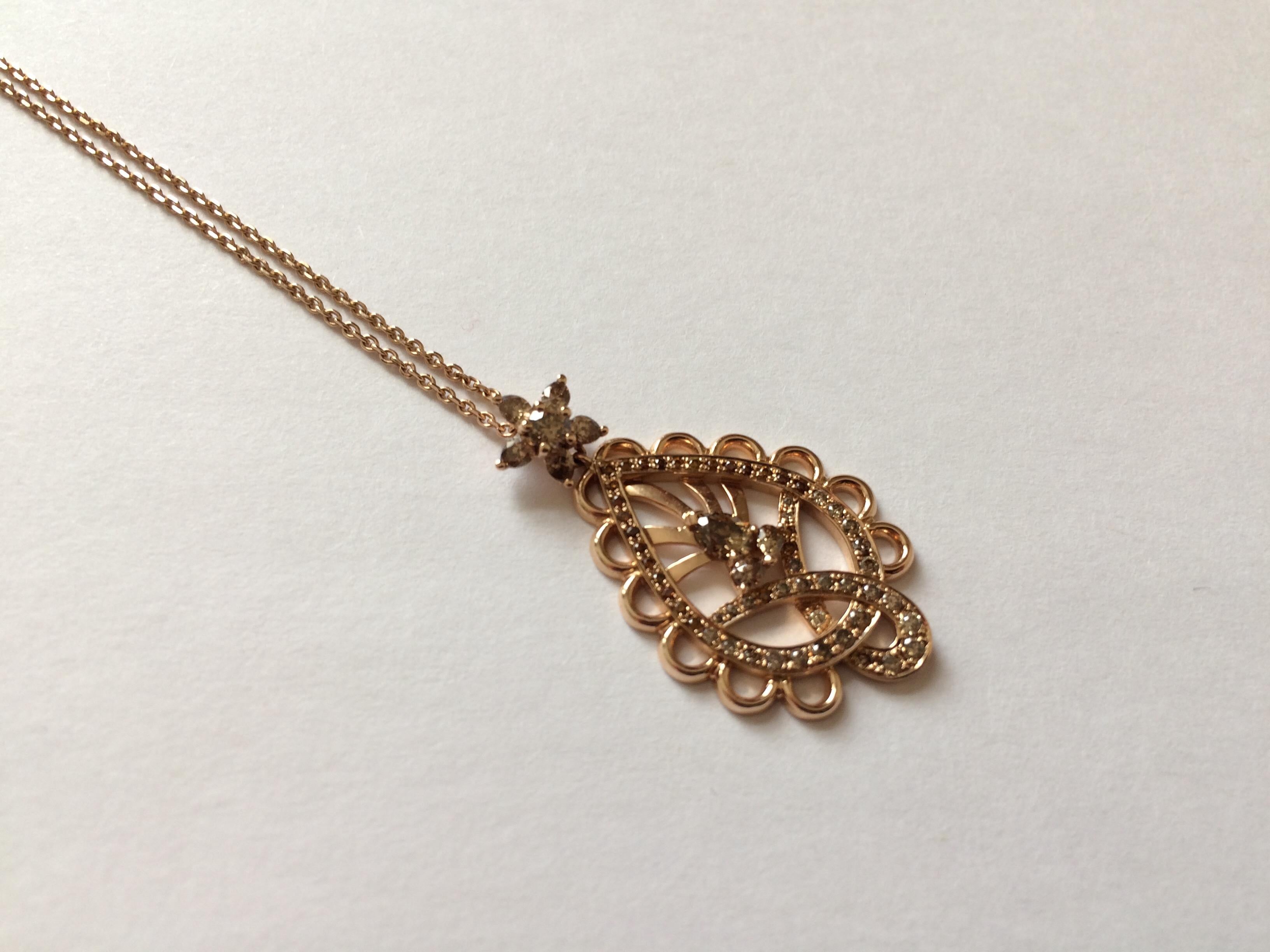 This pendant is handcrafted from 18ct rose gold and set with natural cognac diamonds which total 1.25ct. These stones were hand cut, specifically for this piece. 

Diameter of pendant: 2cm
Length of pendant: 3.5cm

The chain is 41cm long or 16