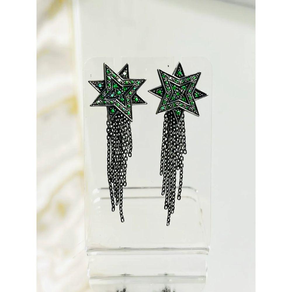 Ana De Costa Shooting Star Earring 18K Gold & Tsavorites

Handmade stars with link multirole link chains, creating an elegant dangle. Blackened 18 white gold with green pave Tsavorites.
From the Alchemy collection.

Additional information:
Size: One