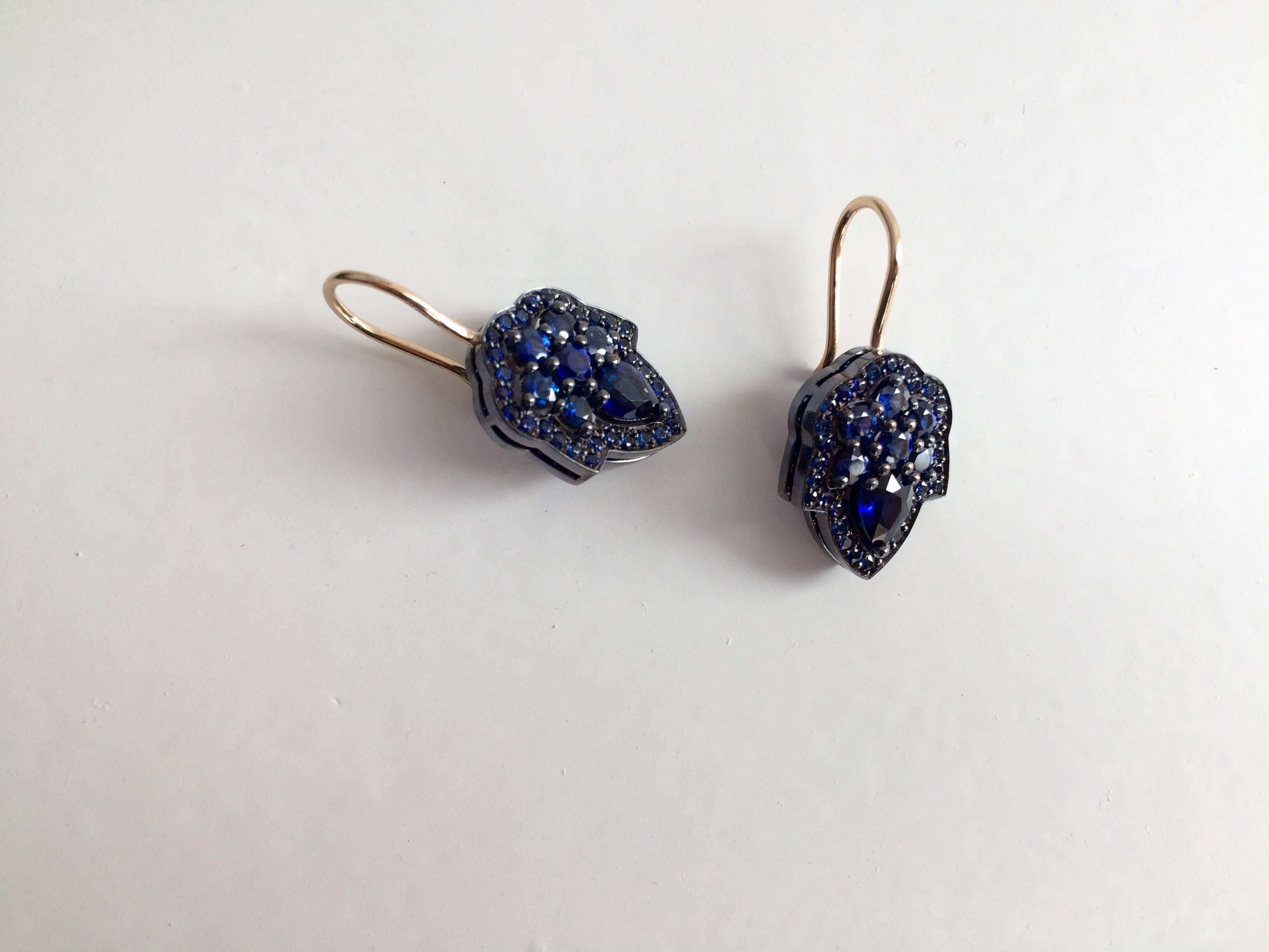 This beautiful pendant has been handcrafted in London from 18ct yellow gold and is set with 1.25ct of blue sapphires. The top and sides of the drop has been finished with a blue gold lacquer to enhance the electric blue colour of the sapphires and