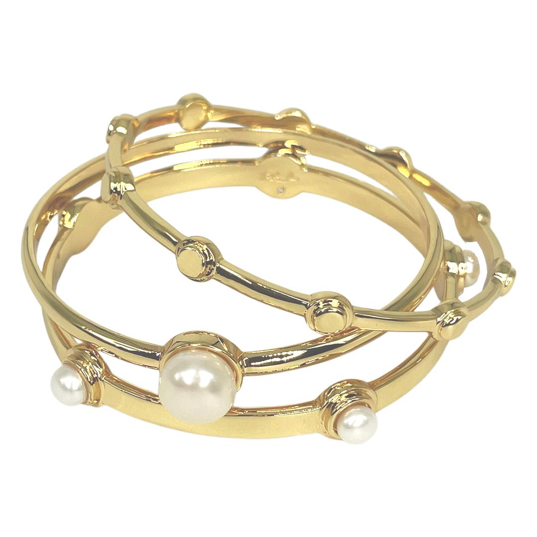 High polished  bangle set perfect for stacking, this set is made from brass plated 14k gold.  Two bangle are accented with bezel set lustrous freshwater pearl cabs, one is metal with Syd+Pia spherical detail.  Layer yours with other Syd + Pia styles