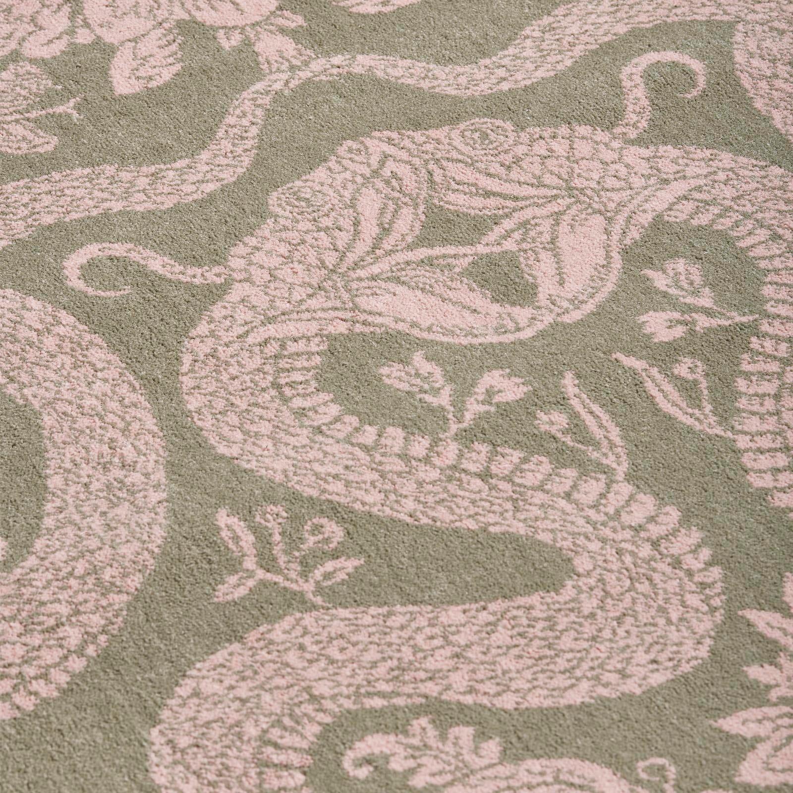 Fear not the snakes slithering across the floor of your home, for these are our House symbols of transformation and renewal. In an elegant palette of sage-green and dusky-pink, the subversively beautiful ANACONDA rug is woven by Axminster Carpets,