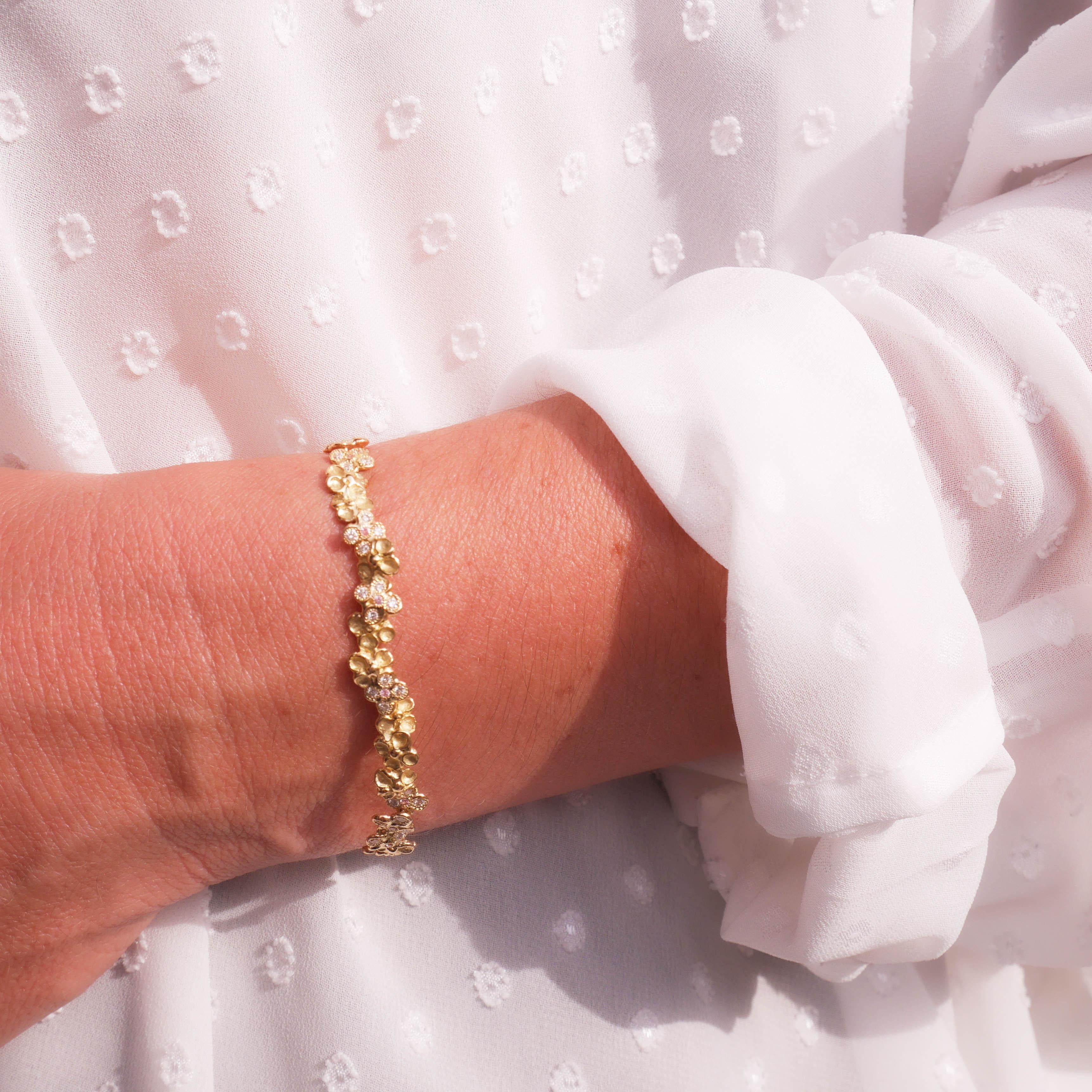 This one-of-a-kind bracelet is expertly crafted from 18 Karat yellow gold 11 grama approximately. 
It is articulated for it to fall perfectly on your wrist. 
Embellished by diamonds and pink sapphires. 
The craftsmanship is entirely hand made with