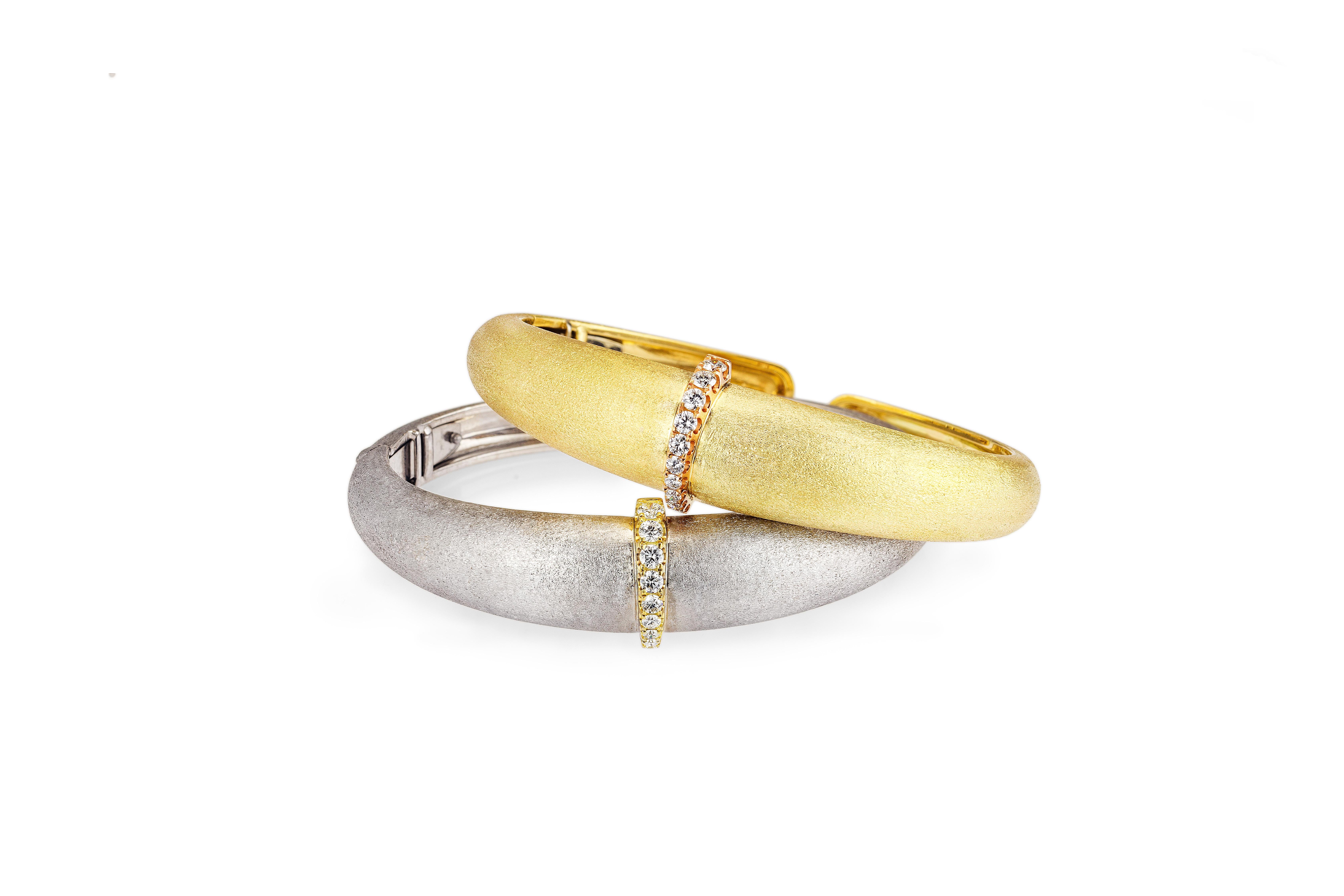 A statement piece in 18k yellow gold with a stone etched finish to resemble raw silk.  A yellow gold and white diamond ridge adds an architectural element to the sensual shape. This talisman cuff is inspired by a ring AnaKatarina designed for