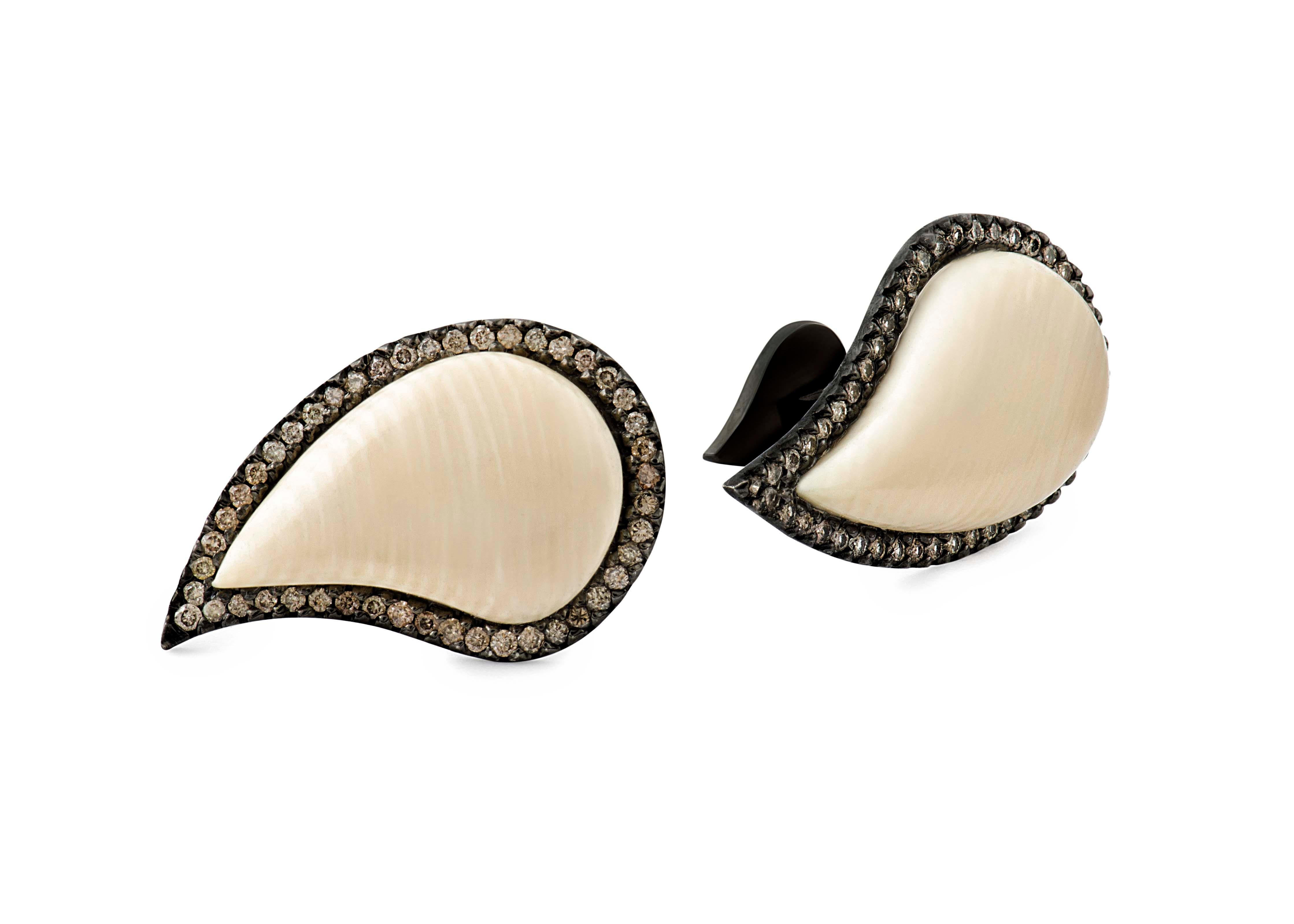 These one-of-a-kind Ishq Cufflinks use prehistoric mammoth ivory from Alaska wrapped in sterling silver and lined with cognac diamonds to capture the timeless beauty of paisley's organic form. The intricate 