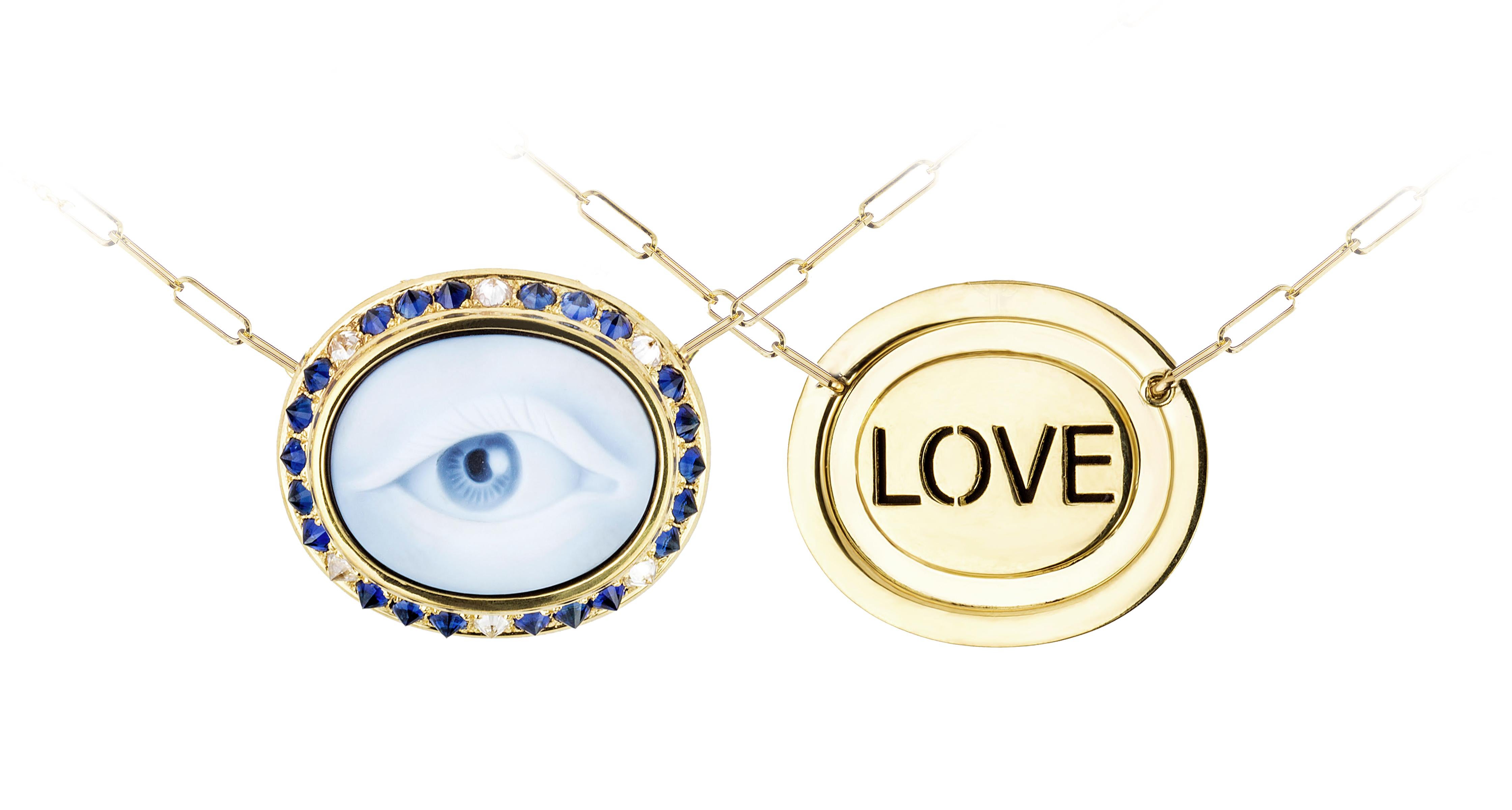 The blue agate cameo is hand created by a master carver bringing out the colors and depth within the layers of the stone. The cameo is encased in yellow gold, inverted diamonds, and sapphires. On each Eye Love Cameo necklace, ‘LOVE’ is found on the