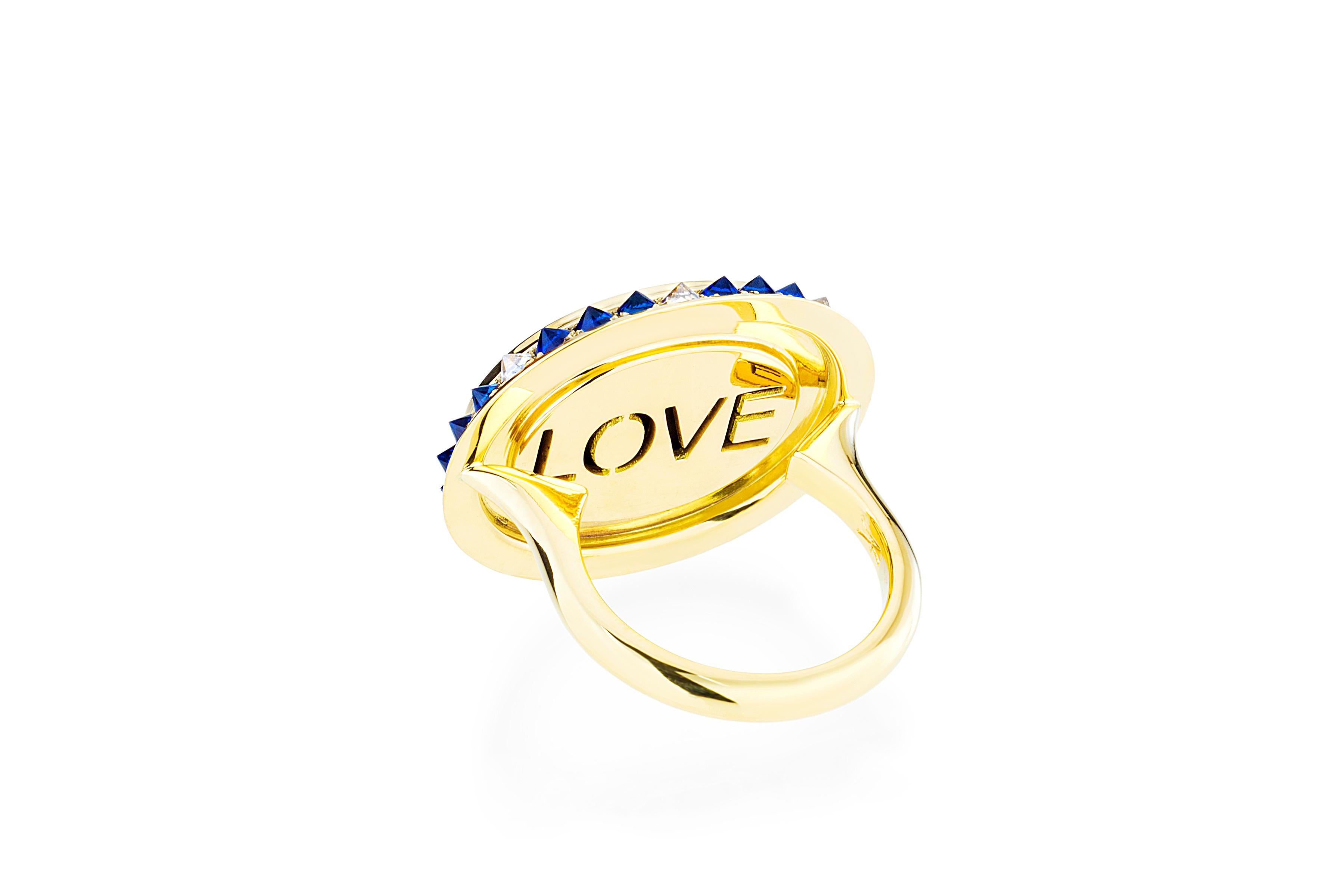 The blue agate cameo in the 'Eye Love Ring' is hand created by a master carver bringing out the colors and depth within the layers of the stone. The cameo is encased in yellow gold, inverted diamonds, and sapphires. As in every piece of the Eye Love