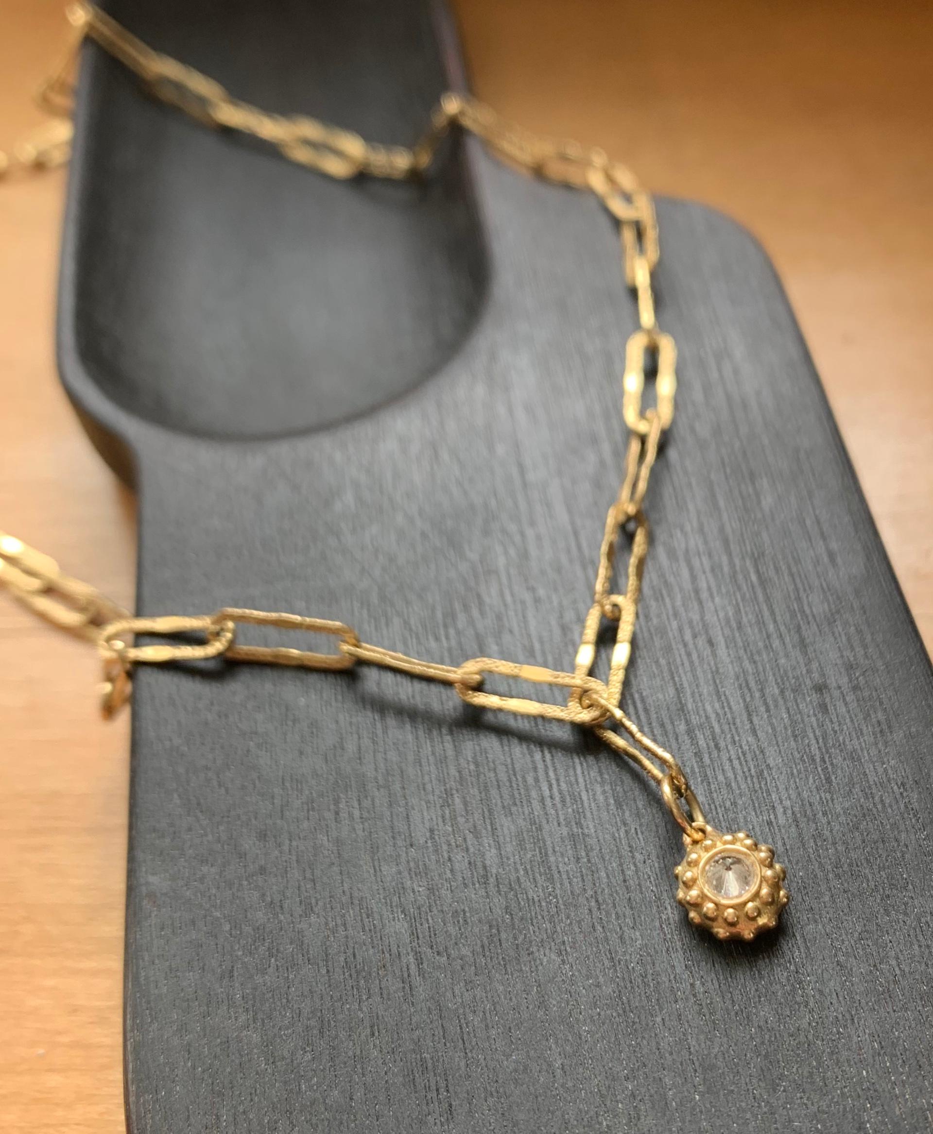 An inverted white diamond is set in an organic form of yellow gold suspended from a stunning hand-made chain to create the simple and elegant 'California Dreaming' Necklace. The hand-made 18k gold chain has a stone-etched finish creating a texture