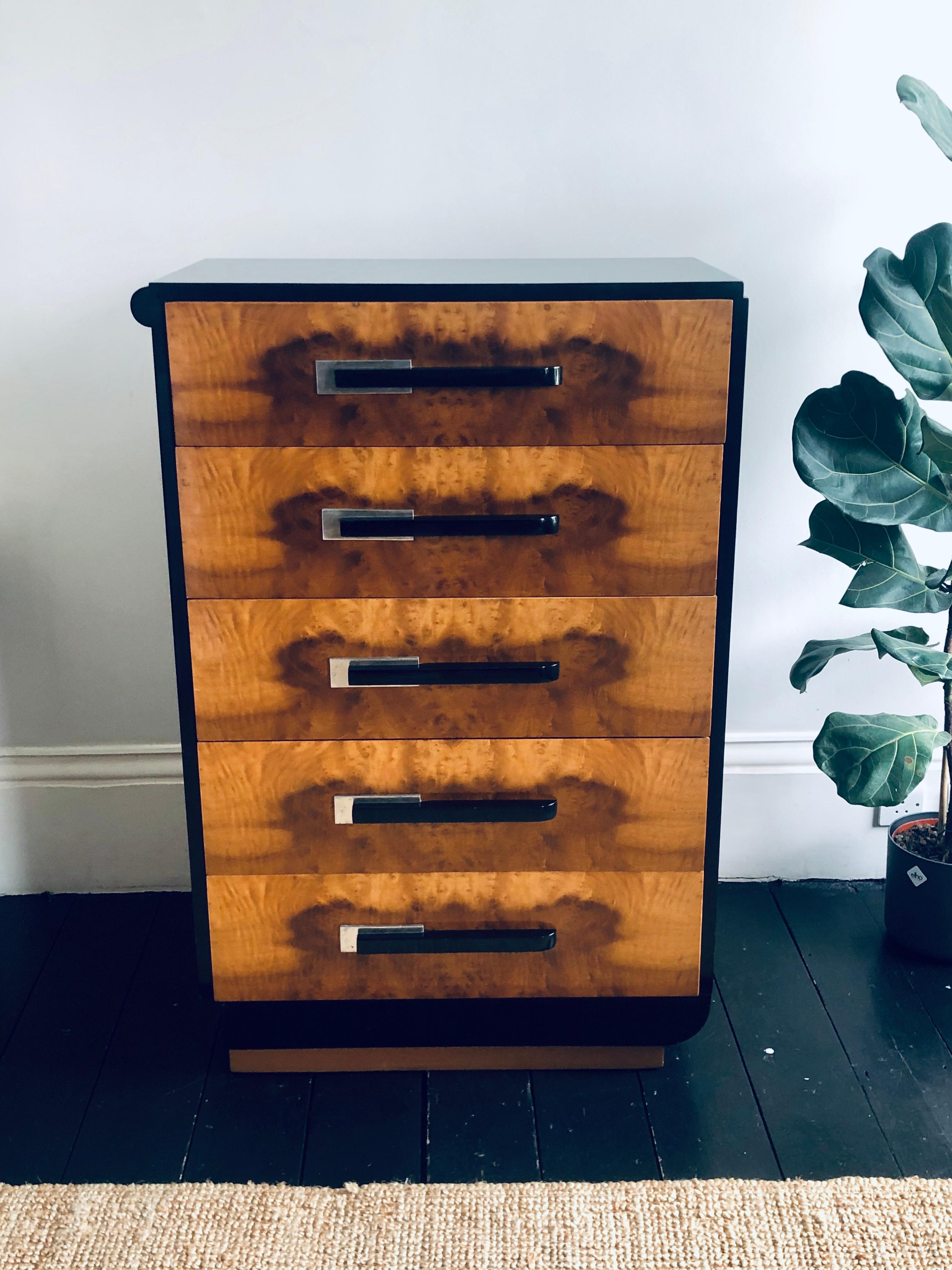 An Art Deco style chest of five long burr birch drawers each fitted with asymmetric silvered metal and ebonised handle
The chest made by “Widdicomb Furniture Co. The back of the chest has a metal plaque” USA true grand rapids cabinet making