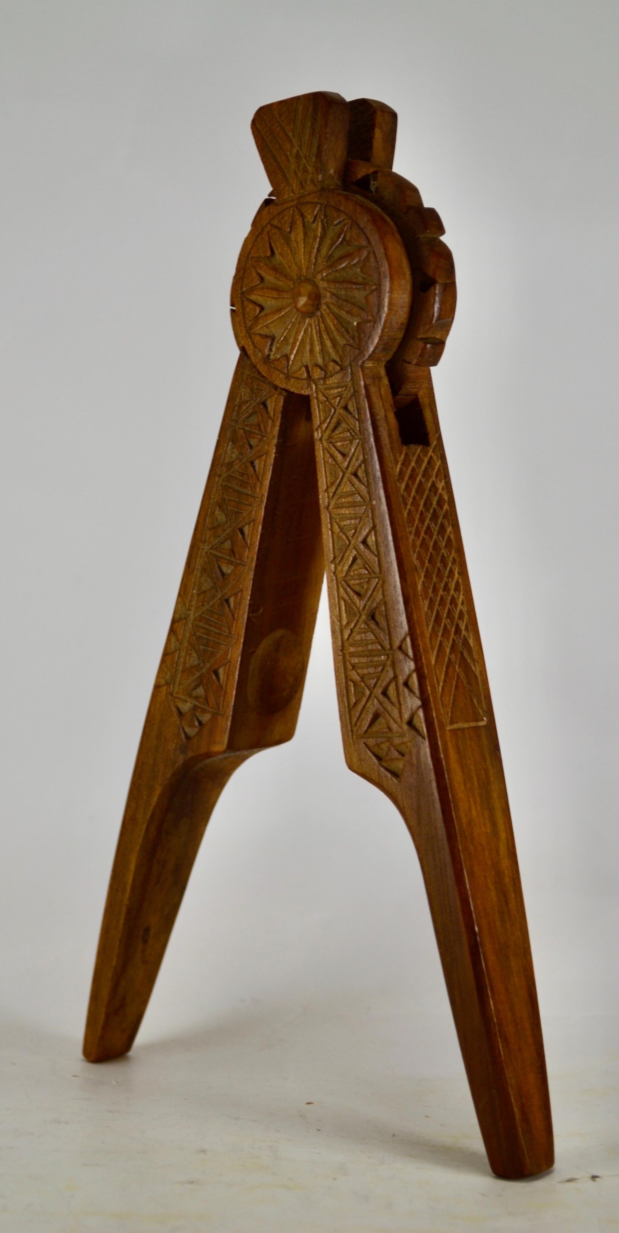 A magnificent antique wooden nutcracker, a true piece of folk art from the early 20th century. Crafted with exceptional artisanal skill, this unique item combines utility and rustic charm. With its carved details and natural patina, it bears witness