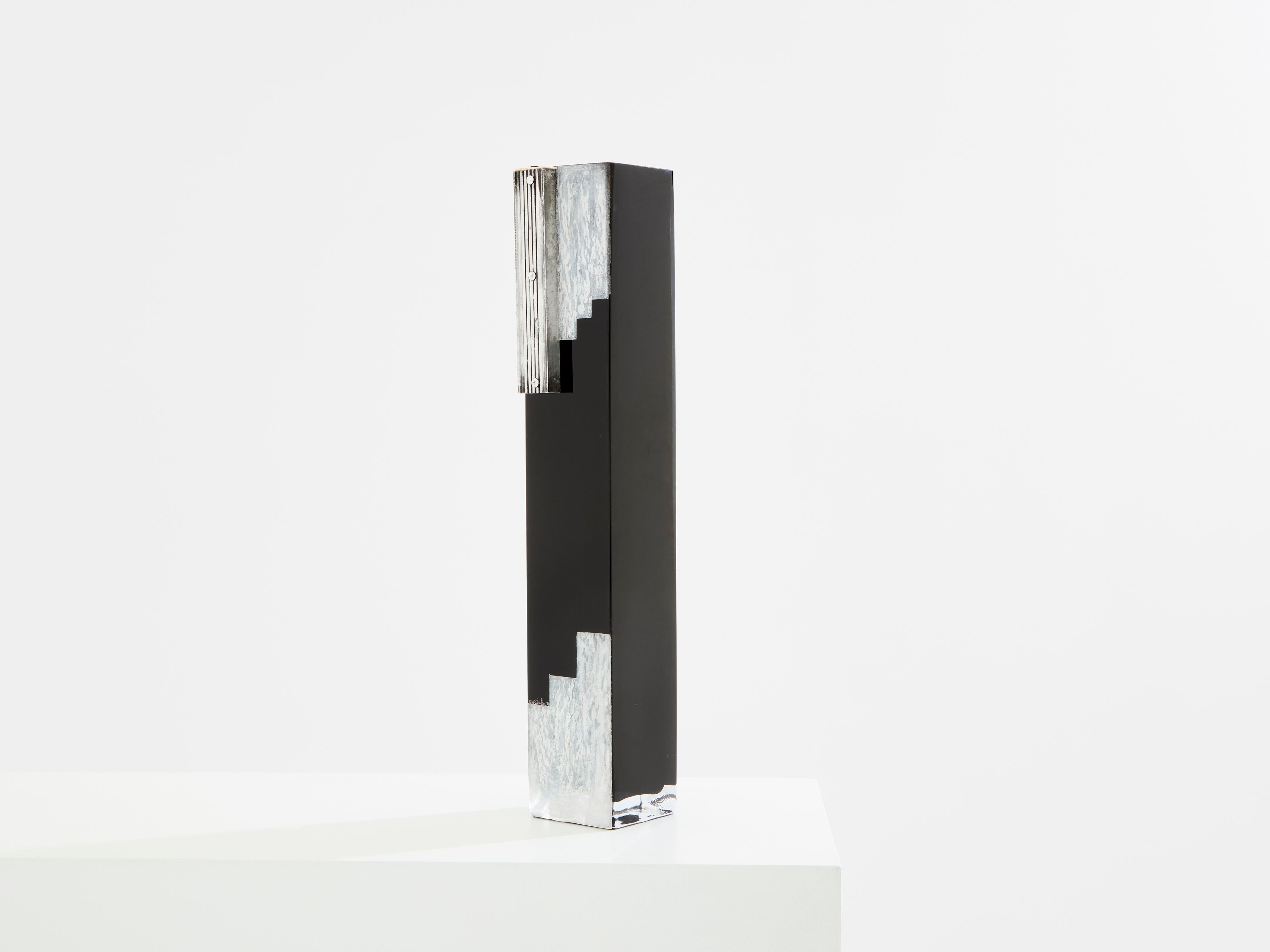 This tall Art Deco vase in black opaline glass, with white painted decor, and chromed steel piece add-on, is signed by the Russian artist Anatole Riecke, and dated 1939. As the Master Glassmaker of La Coupole in Paris, he was responsible for the