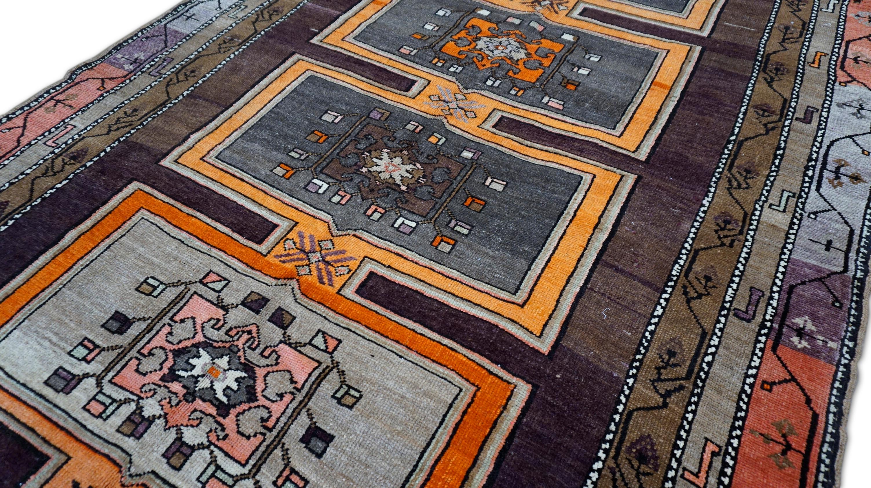 This striking vintage hand-knotted wool rug features a bold, geometric tribal aesthetic rooted in early-20th-century village weaving traditions. The rug’s strong architectural composition and saturated natural dyes make it a standout textile,