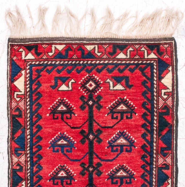 Turkish Anatolian hand-woven carpet with a pictorial tree of life design within a repeating geometric pattern border on a red ground.

Dealer: S138XX