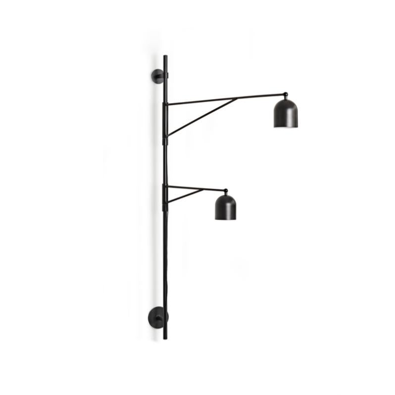 Wall lamp designed by Anatomy Design in 2012. 

Quirky and slightly off, Awkward is a wall lamp with a deliberately peculiar anatomy - its long, slender arms reaching to illuminate two areas in close proximity: two sides of a sofa or both an