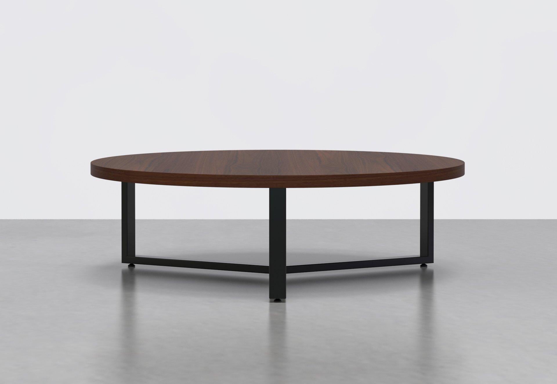Simplicity and sophistication in one. The Anchor coffee table's essential powder-coated steel base supports a durable round veneer top.