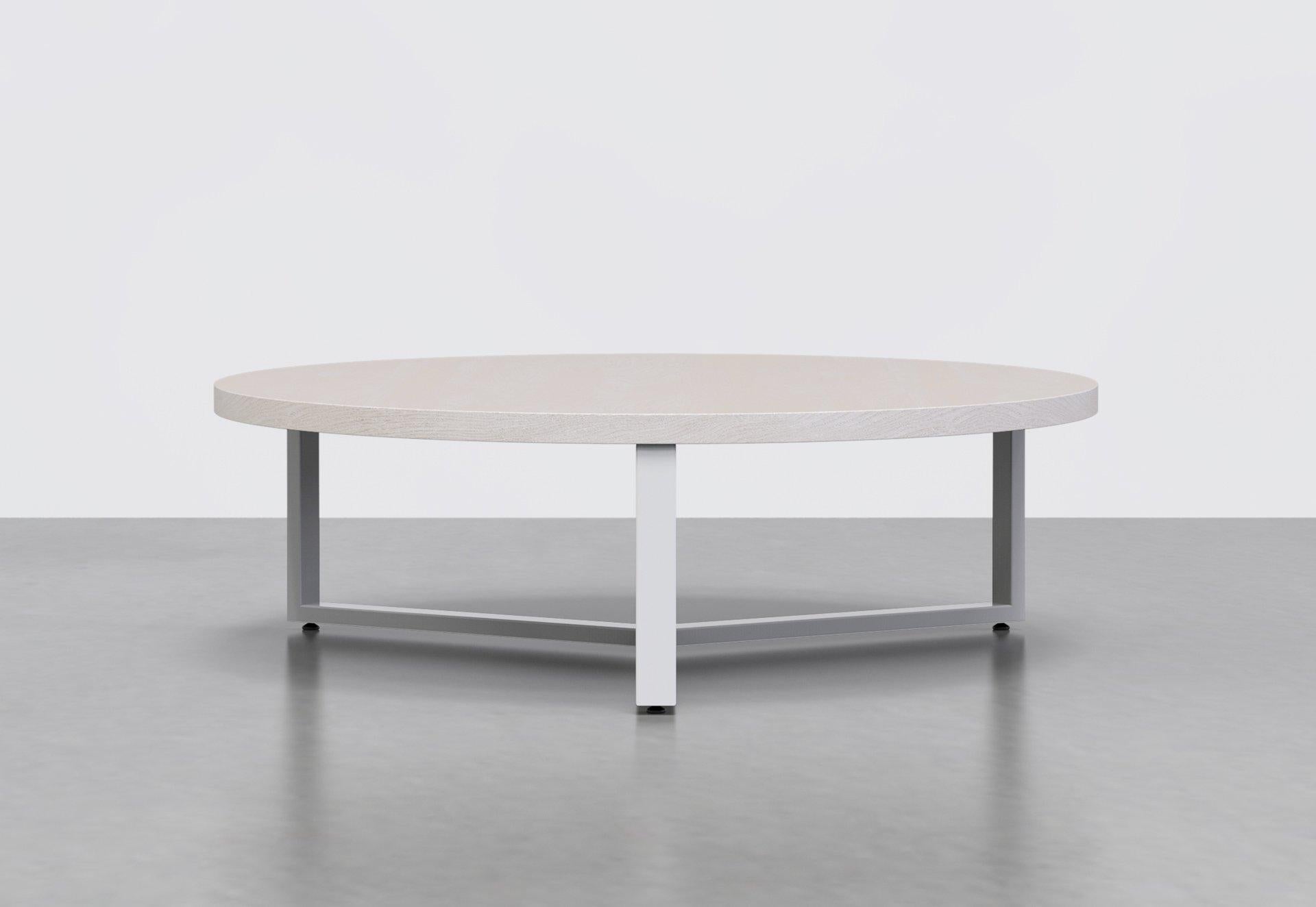 Simplicity and sophistication in one. The anchor coffee table's essential powder-coated steel base supports a durable round veneer top.