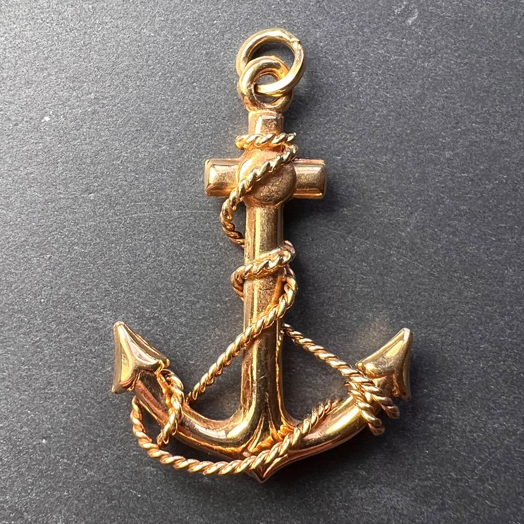 A 14 karat (14K) hollow yellow gold pendant designed as an anchor entwined with a rope symbolising stability and resiliance in difficult times. Stamped 585 for 14 karat gold to the pendant bail.
 
Dimensions: 3.7 x 2.7 x 0.55 cm (not including jump