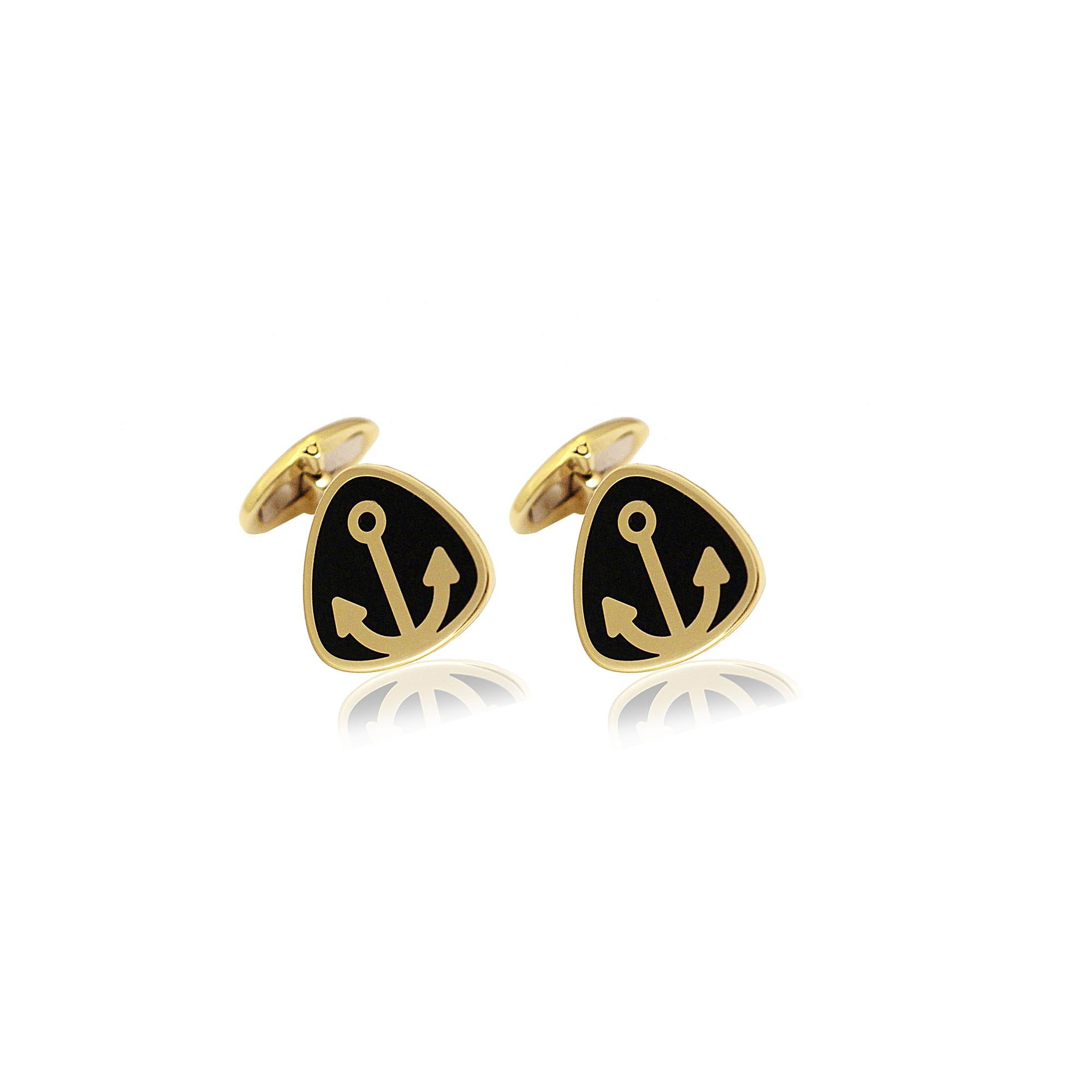 Triangle cufflinks with round angles, handcrafted in 14Kt yellow gold featuring black ceramic -cerachrom- and an anchor in the centre. Inspired from the round angles of the yachts design and anchor symbol that brings good luck to the wearer.. These