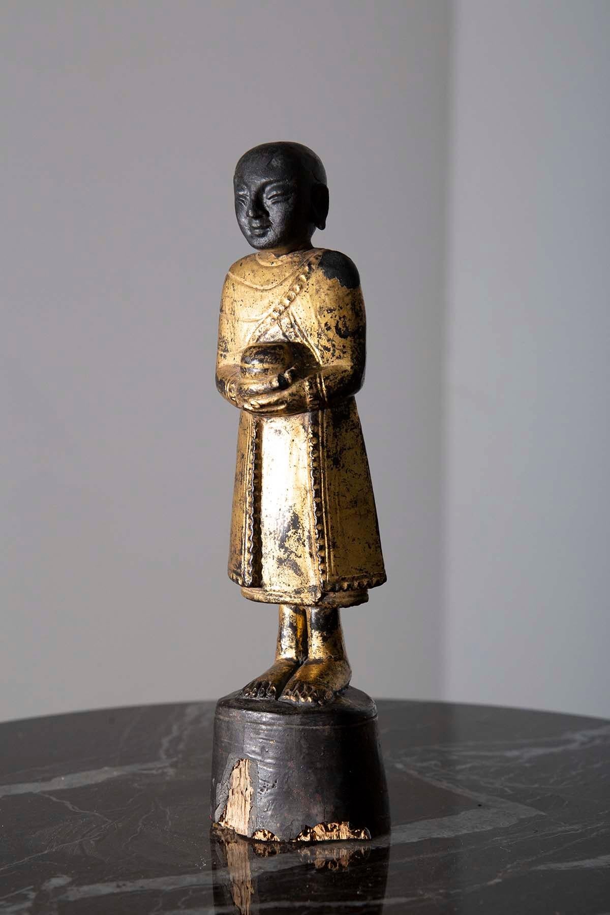 In the early 19th century, amidst the enchanting landscapes of Burma, a masterpiece of profound spiritual significance came to life—a Water-bearing Burmese Buddha, a testament to the devotion and artistry of its creators. This remarkable sculpture,