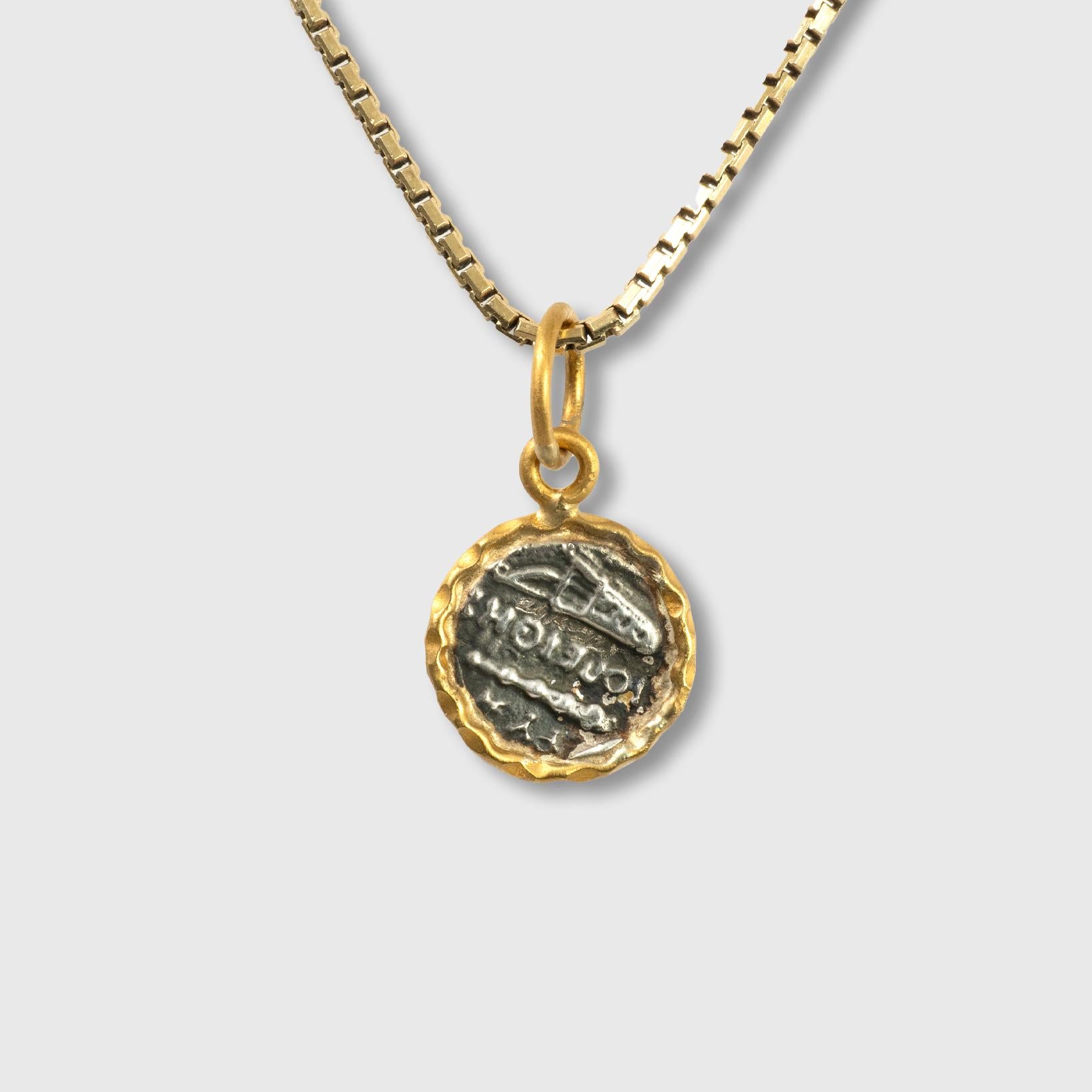 24kt Yellow Gold and Sterling Silver Coin-Charm Pendant Necklace of Athena (Sterling silver coin replica) framed in 24kt Yellow Gold.  

Athena was one of the twelve chief Olympian deities and the goddess associated with wisdom, craft, and warfare.
