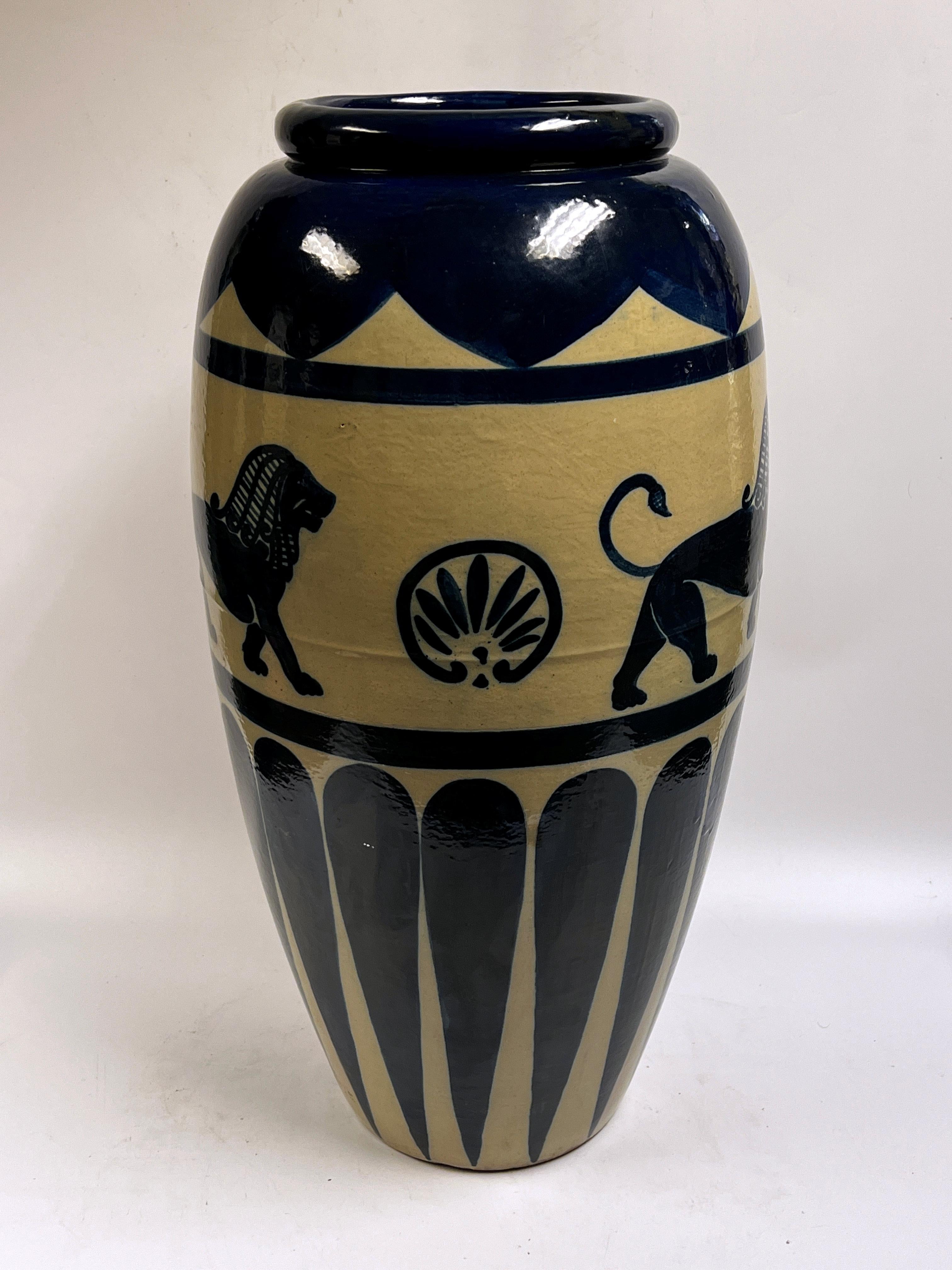 Stoneware jardiniere with cobalt blue glaze and ancient designs including standing lion in the ancient Babylonian style and Egyptian palmettes.