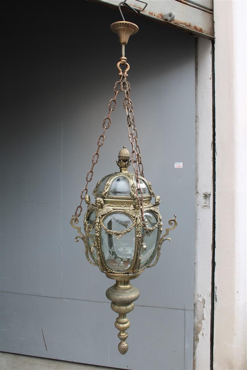 Ancient Baroque style lantern in bronze fusion with little angels and various curved glass embroideries.