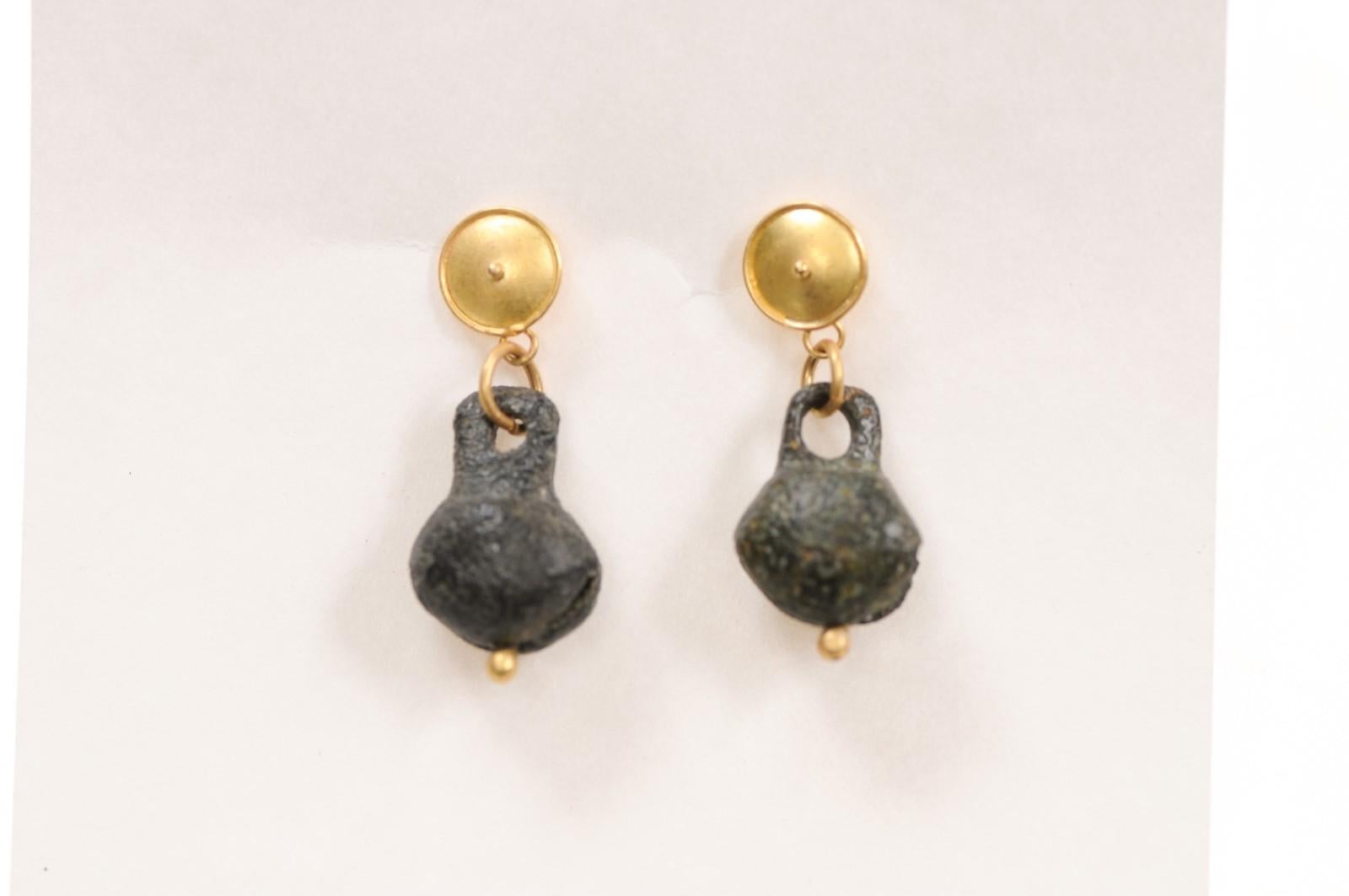 A pair of ancient Roman bells fashioned into whimsical dangle earrings with 21K gold accents and Etruscan inspired posts. There is a marvelous patina that demonstrates the age of the bells. These are from the 1st to 3rd Century AD and were created