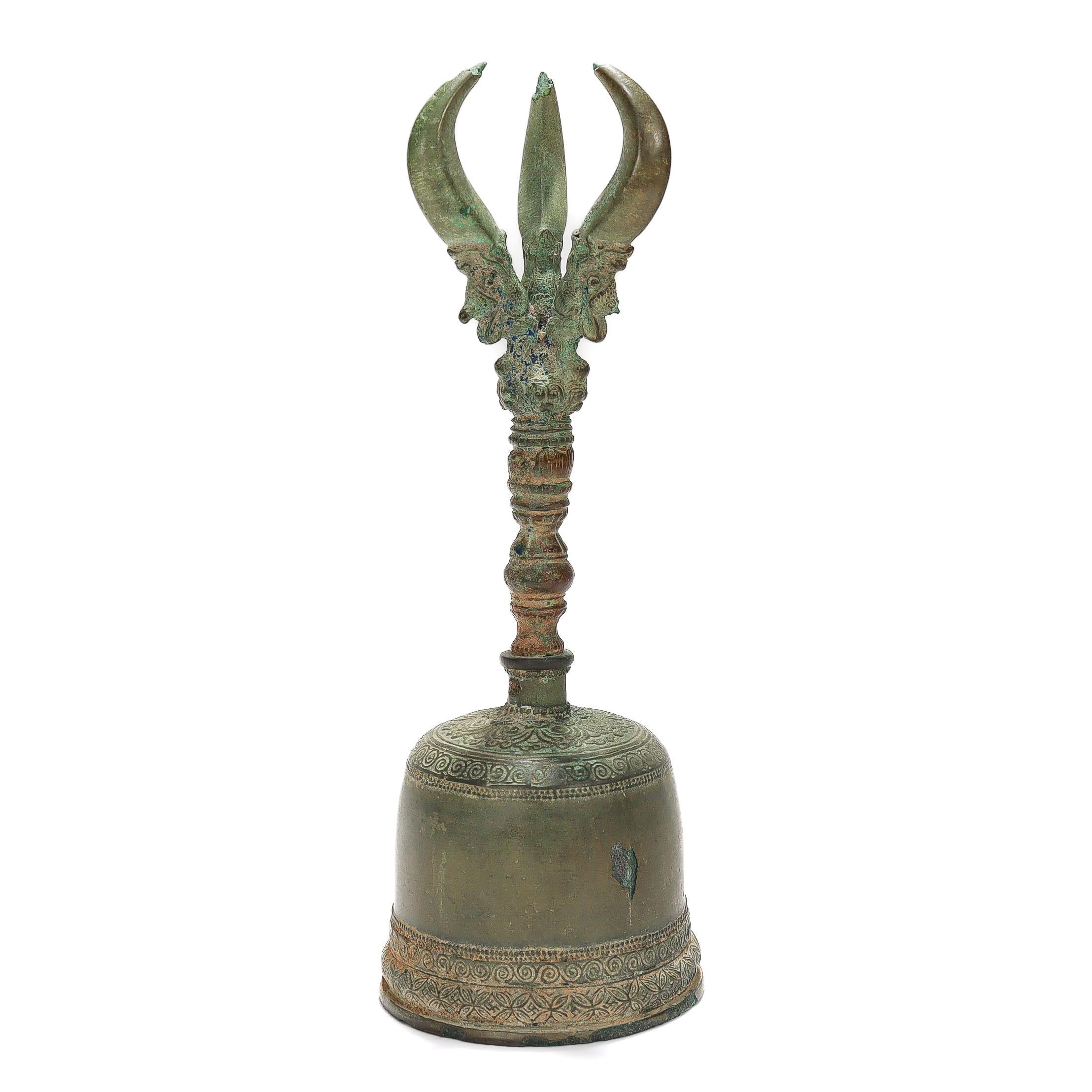 A fine ancient bronze ghanta bell.

In a Buddhist style.

With engraved and embossed geometric decoration to the bell body.

The handle with a 3 point vajra device with each point emanating from figural dragon's mouths.

Lacks a clapper.

Simply a