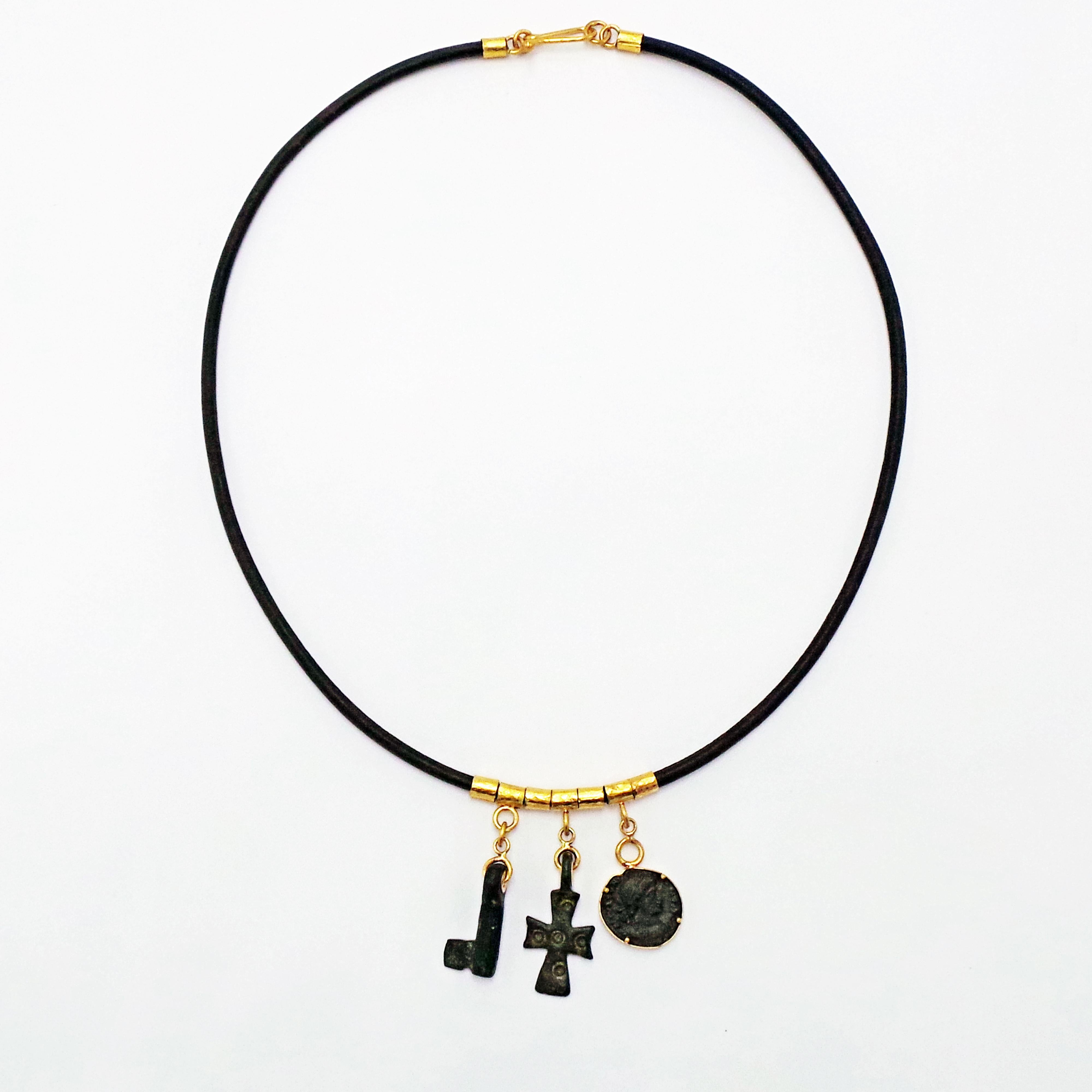 Dark brown leather necklace featuring authentic ancient bronze Roman coin (Constantius II, 337-361 AD), Byzantine bronze cross (4th-6th century, AD) and Roman bronze key (1st-3rd century, AD), along with 22k yellow gold tube links.  All settings and