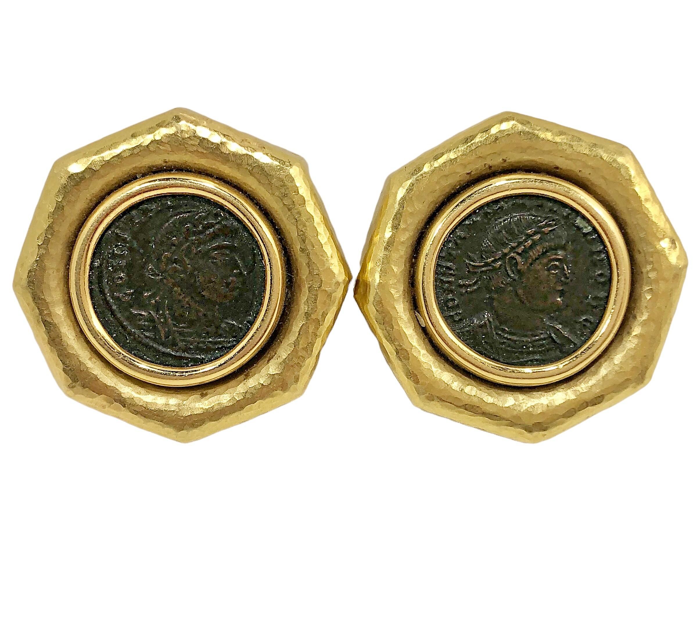 These impressive, hammered finish, 18K yellow gold earrings are set with ancient bronze bronze coins in the center. Point to point, their diameter measures  1 1/8 inches.  Stamped 18K and 750, and the Milan workshop mark. Backs are omega clip style.