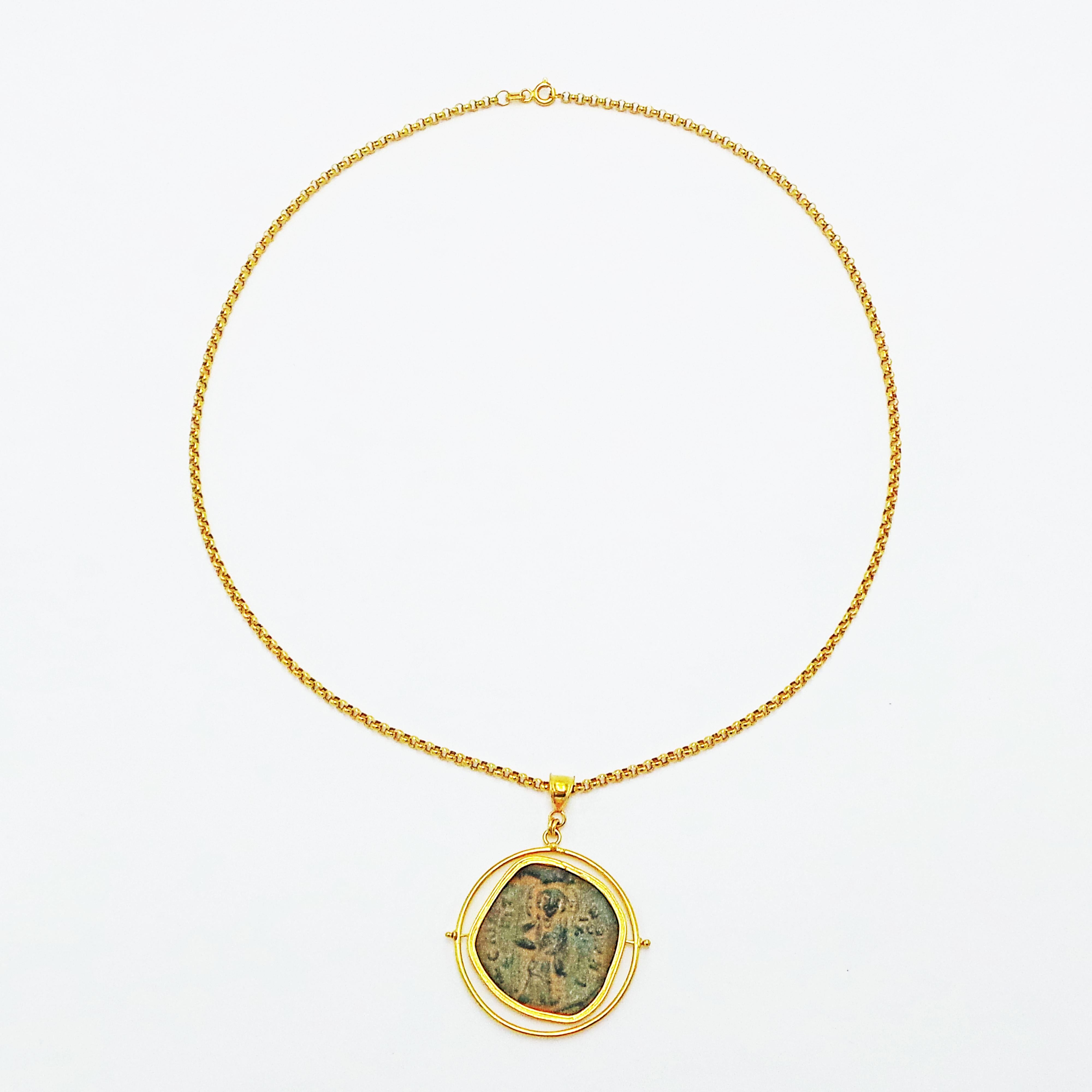 Both sides of this ancient Byzantine coin (Kōnstantinos X, Follis, Constantinopolis mint, AD 1059-1067) can be showcased in this 22k yellow gold spinner/reversible pendant. Coin pendant is on a solid 22k yellow gold 18 inch rolo chain necklace. Rare