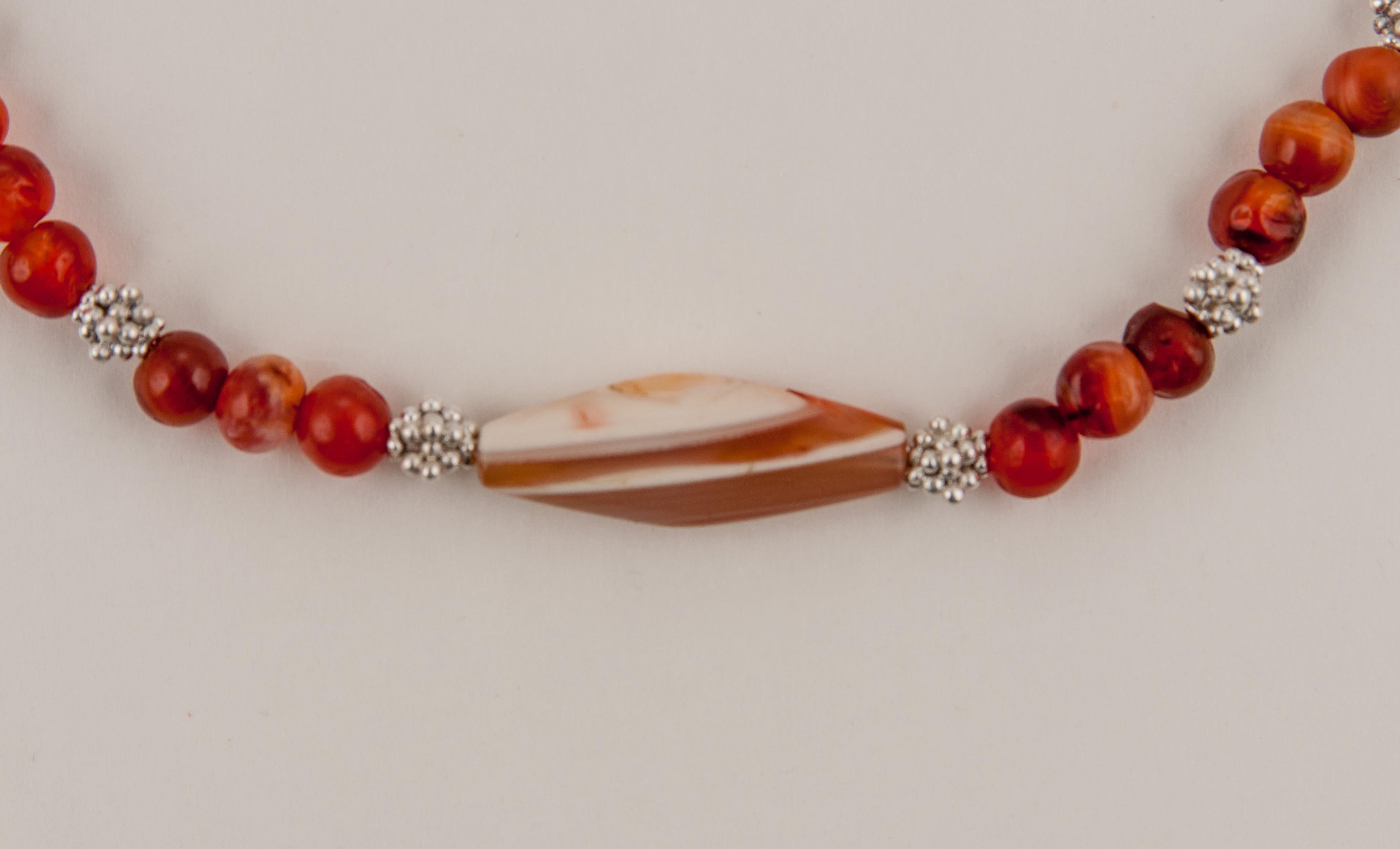 These beads come from the Swat Valley in what is now northern Pakistan and are most likely over two thousand years old. The necklace consists of fifty-four round carnelian beads with a trapezoidal agate bead in the center. There are eighteen