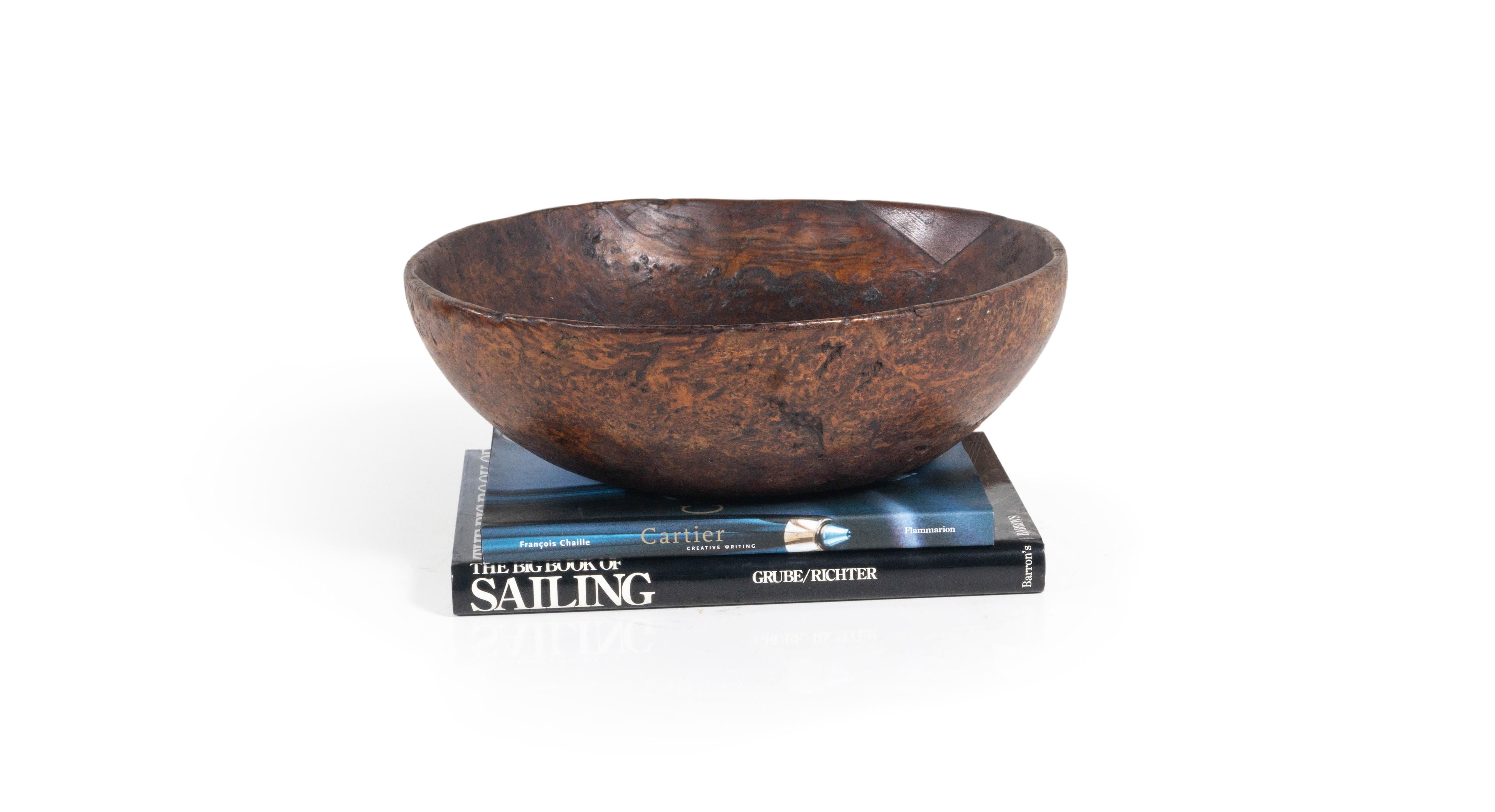 Large Native American ash burl wood bowl. This bowl features an ancient rim repair and bears a rich patina that is a result of many years of use. This piece fits perfectly within a collection or as a stand alone piece rich in color and