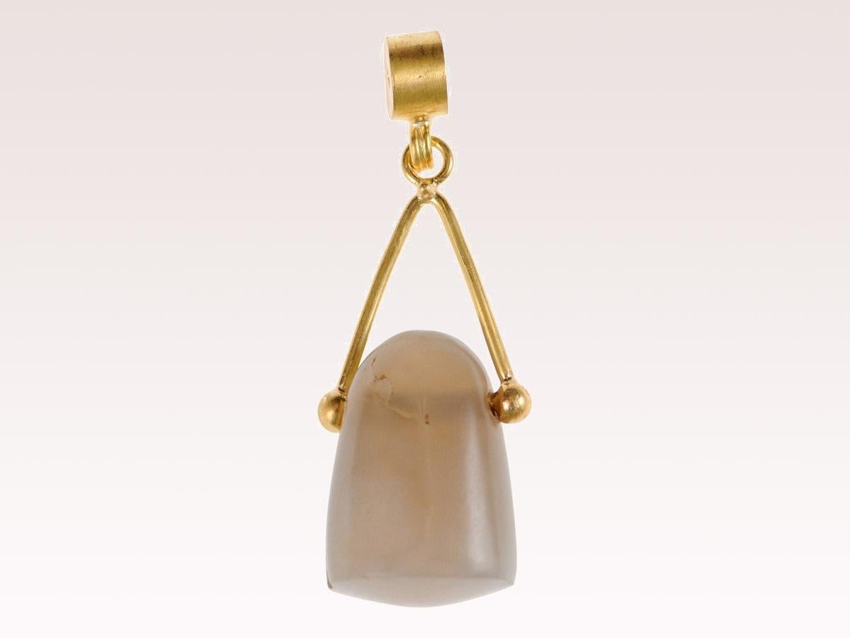 An ancient chalcedony uncarved seal from the middle east, B.C. This ancient uncut seal pendant is on a custom brushed 22k solid gold pendant with 22k gold bail. This pendant features a chalcedony gemstone, which is a type of quartz, and one of the