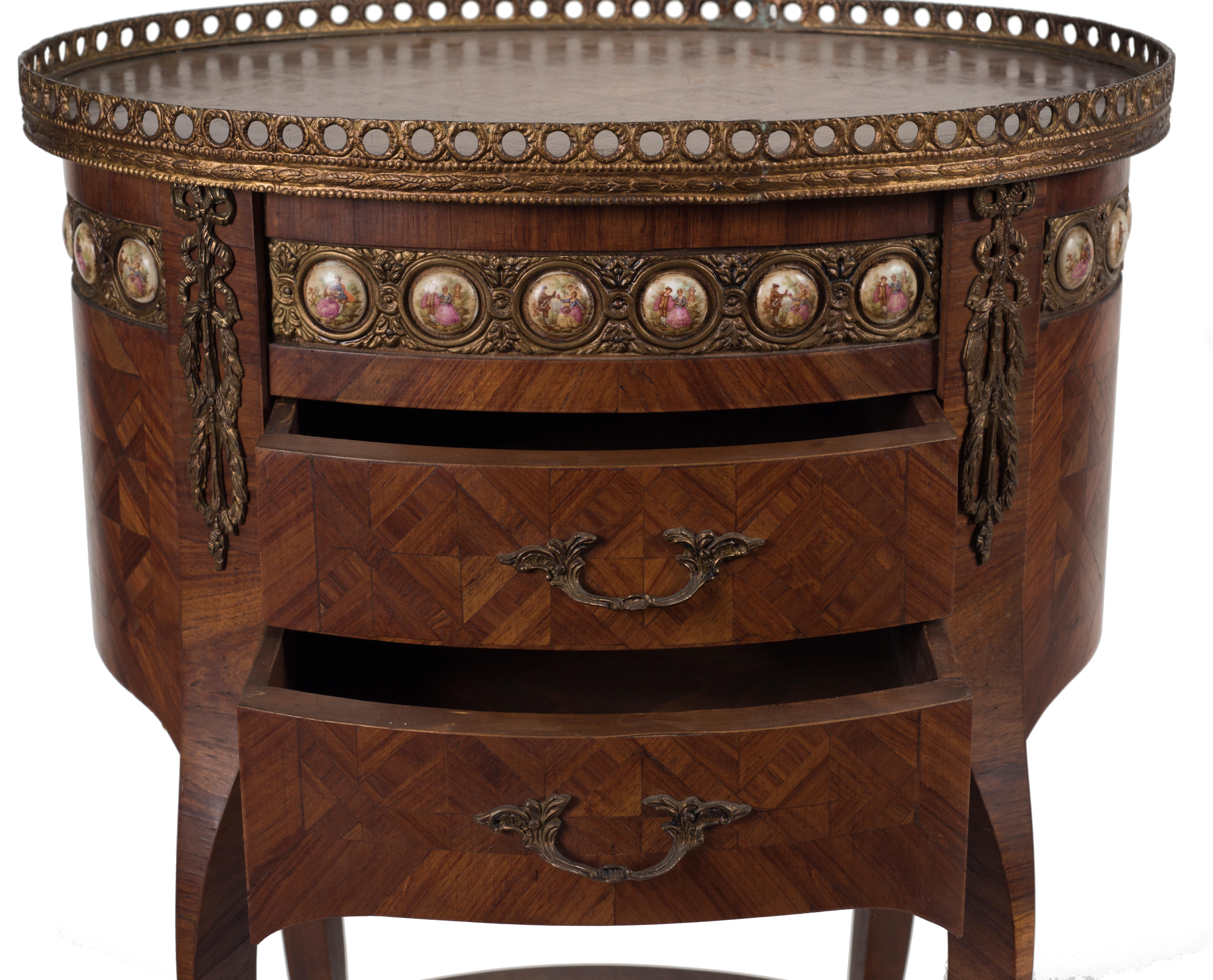 Oval ancient coffee table with 2 drawers on front and bronze decorations. Series of small medallions with genre scenes under the table, surrounded by a bronze banister.
France, end of 19th century.
Good conditions.

This object is shipped from