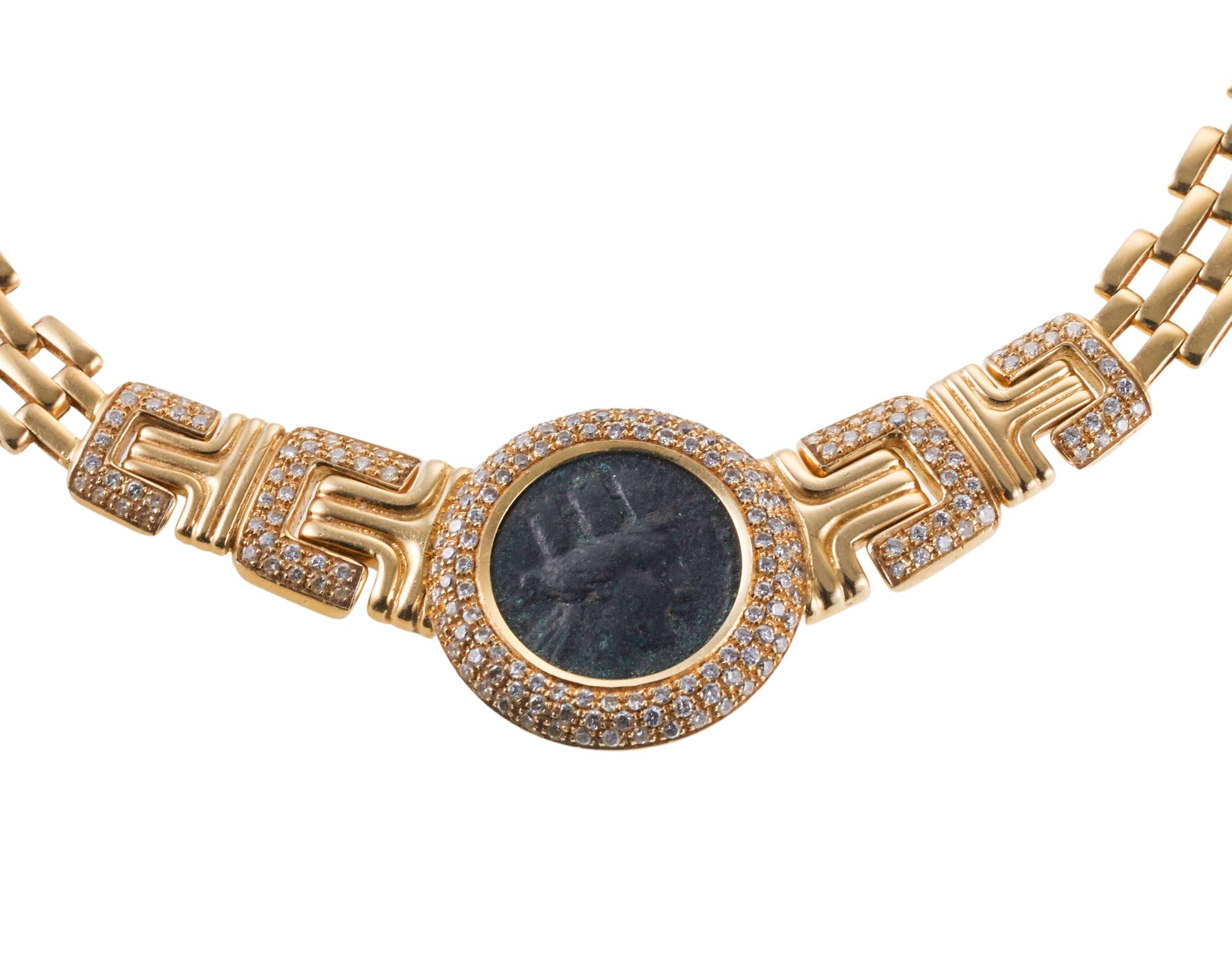 Vintage, circa 1980s 18k gold necklace, featuring center bezel set antient coin, measuring approx. 18mm (allowed by the setting), surrounded with approx. 0.70ctw H/Si diamonds. Le collier mesure 18