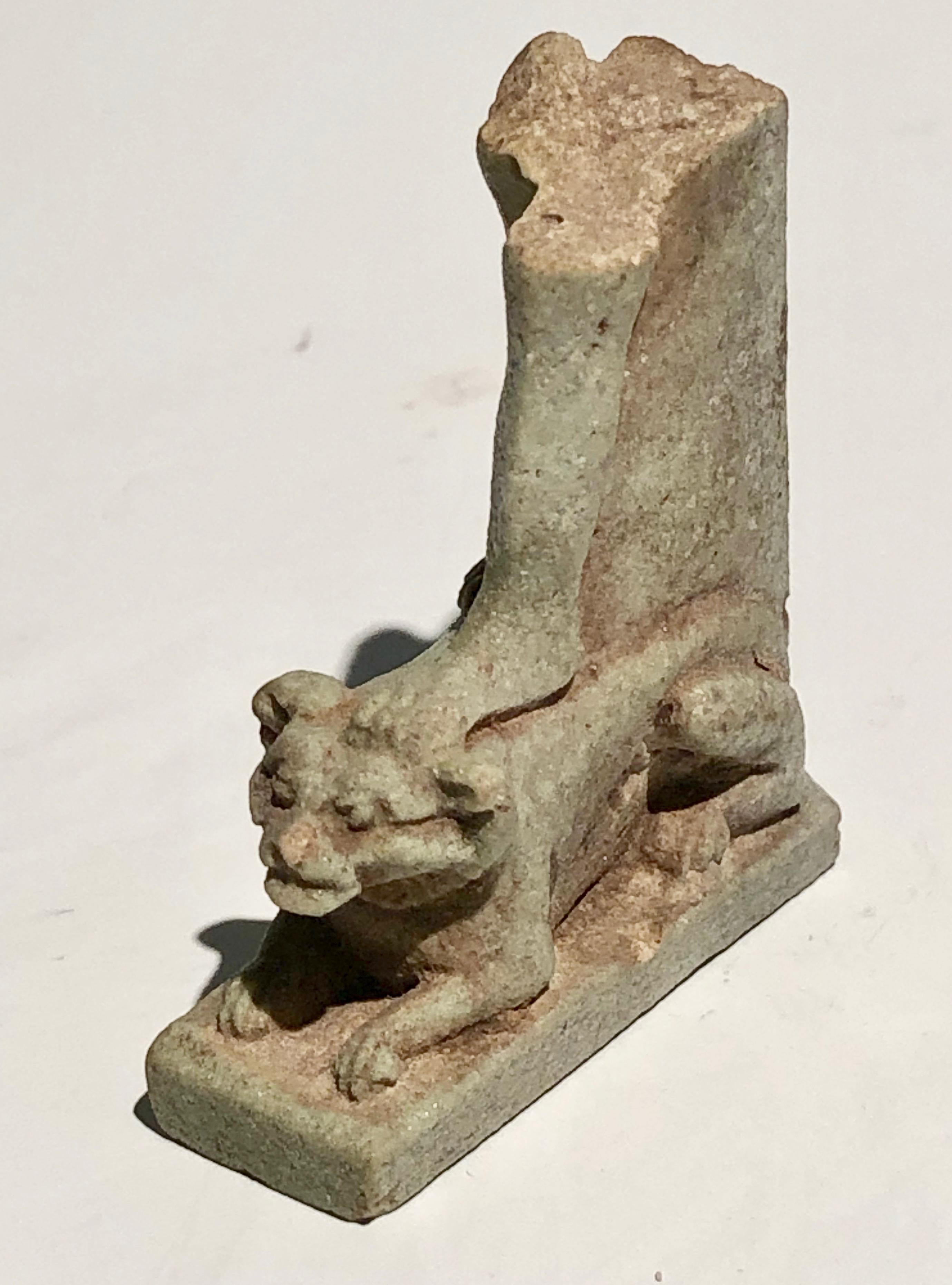 Ancient Egyptian light green composition amulet fragment with preserved Sphinx. Preserved are also the legs from knee height that belong to the missing part of a god or king. Egypt, Third Intermediate Period (1069-525 BC). Provenance: the estate of