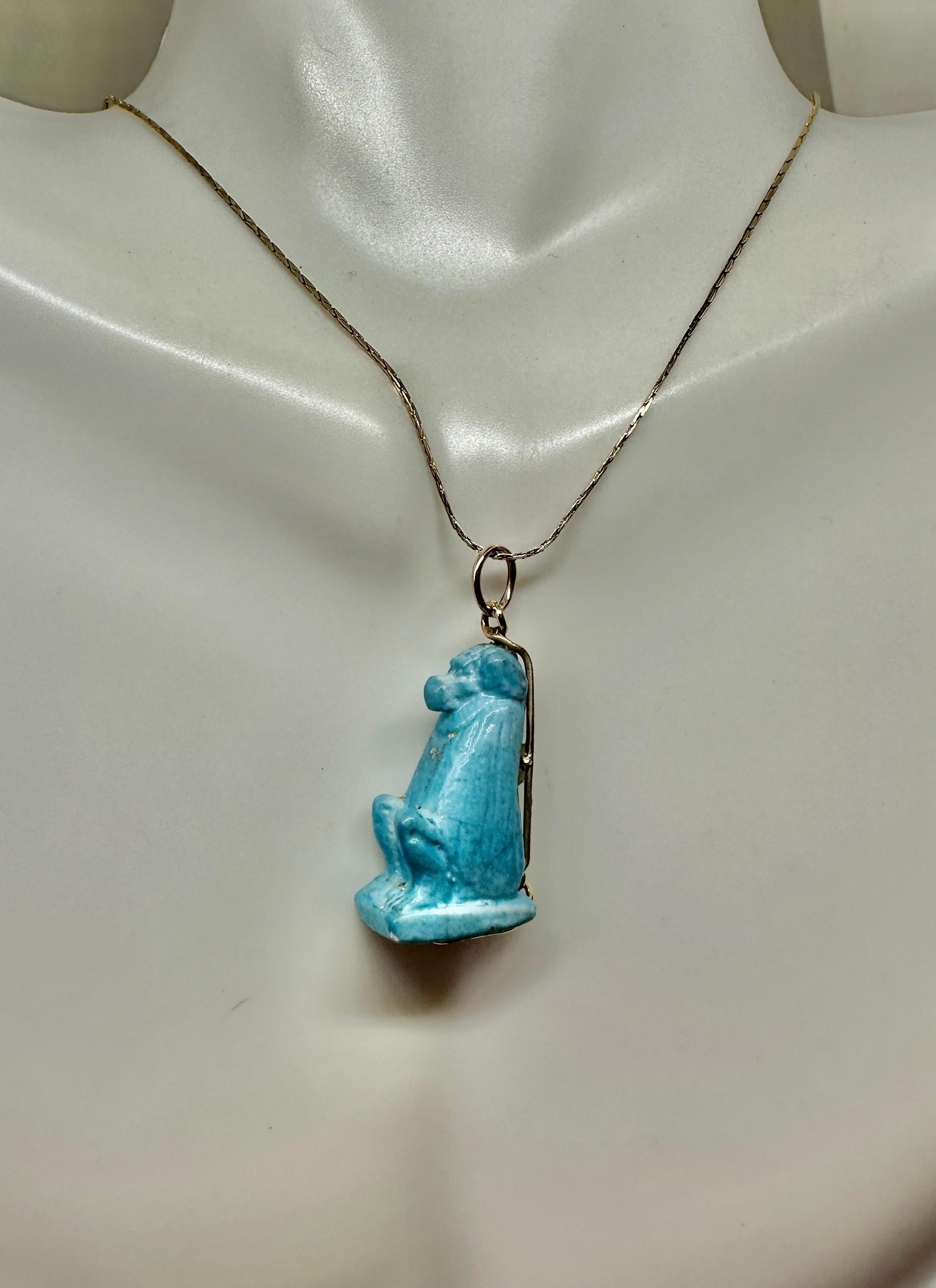 This is a rare museum quality Ancient Egyptian Faience Amulet Pendant depicting a Baboon Monkey, the God Thoth in Ancient Egypt.  Thoth was the god of wisdom.  The fabulous faience Baboon crafted between 700-300 BC, is a miniature masterpiece.  The