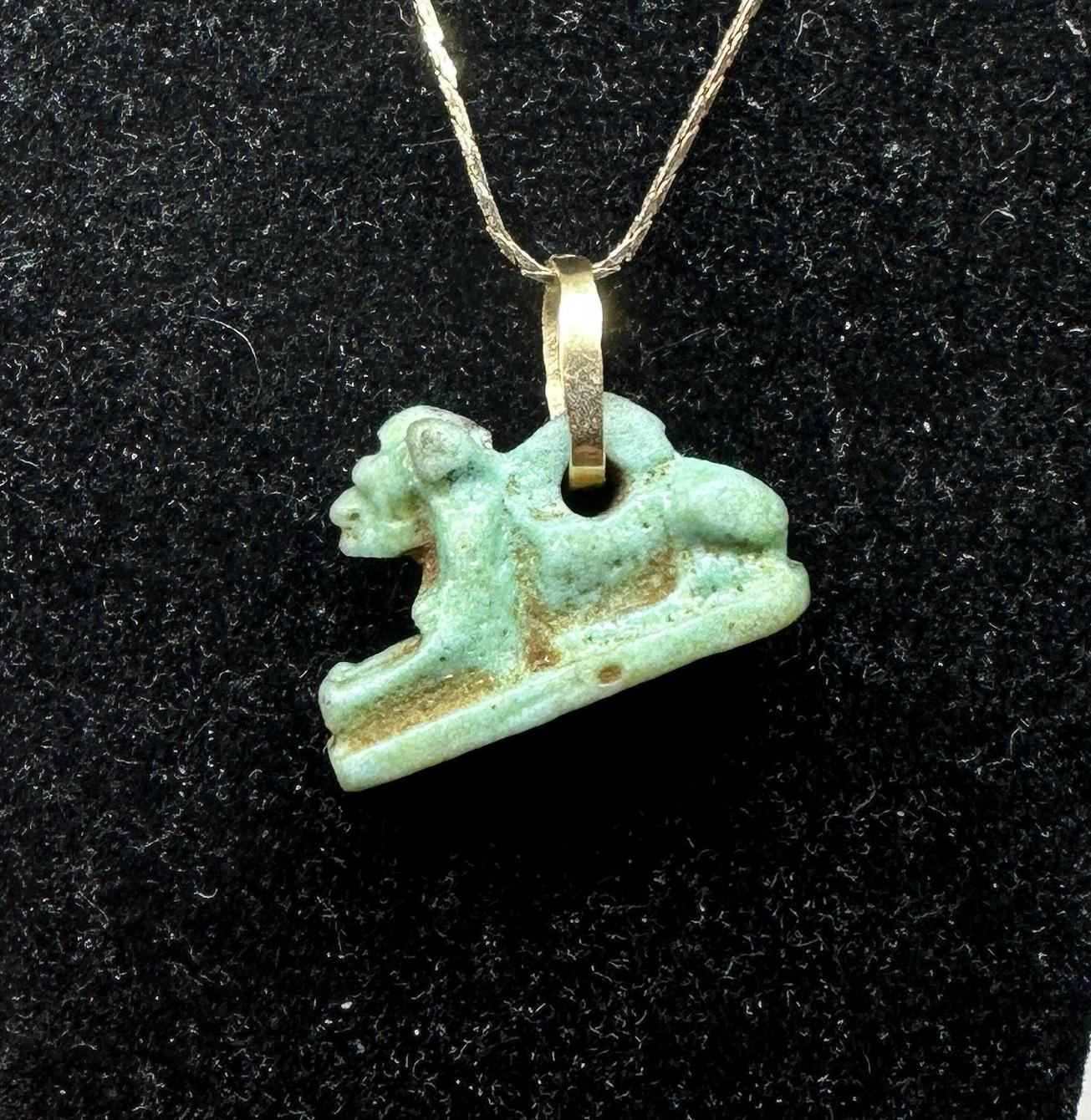 This rare Ancient Egyptian Faience Amulet Pendant depicts the Goddess Sekhmet the Lion, the healing patron of physicians. The faience lion crafted between 700-300 BC, is a miniature masterpiece. The lion amulet is created from fine green-blue