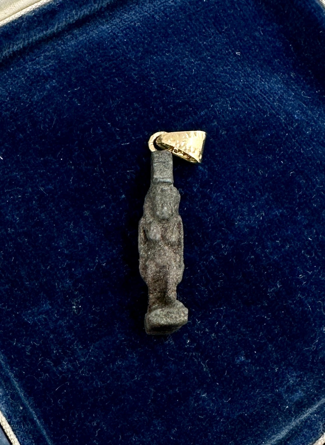 Unveil the elegance of antiquity with this Ancient Egyptian Amulet Pendant Necklace depicting the Goddess Isis, dating from the 600-300 BC with a 14 Karat Gold hand hammered bale.   The exquisite Isis Amulet is a testament to Egyptian artistry.  The