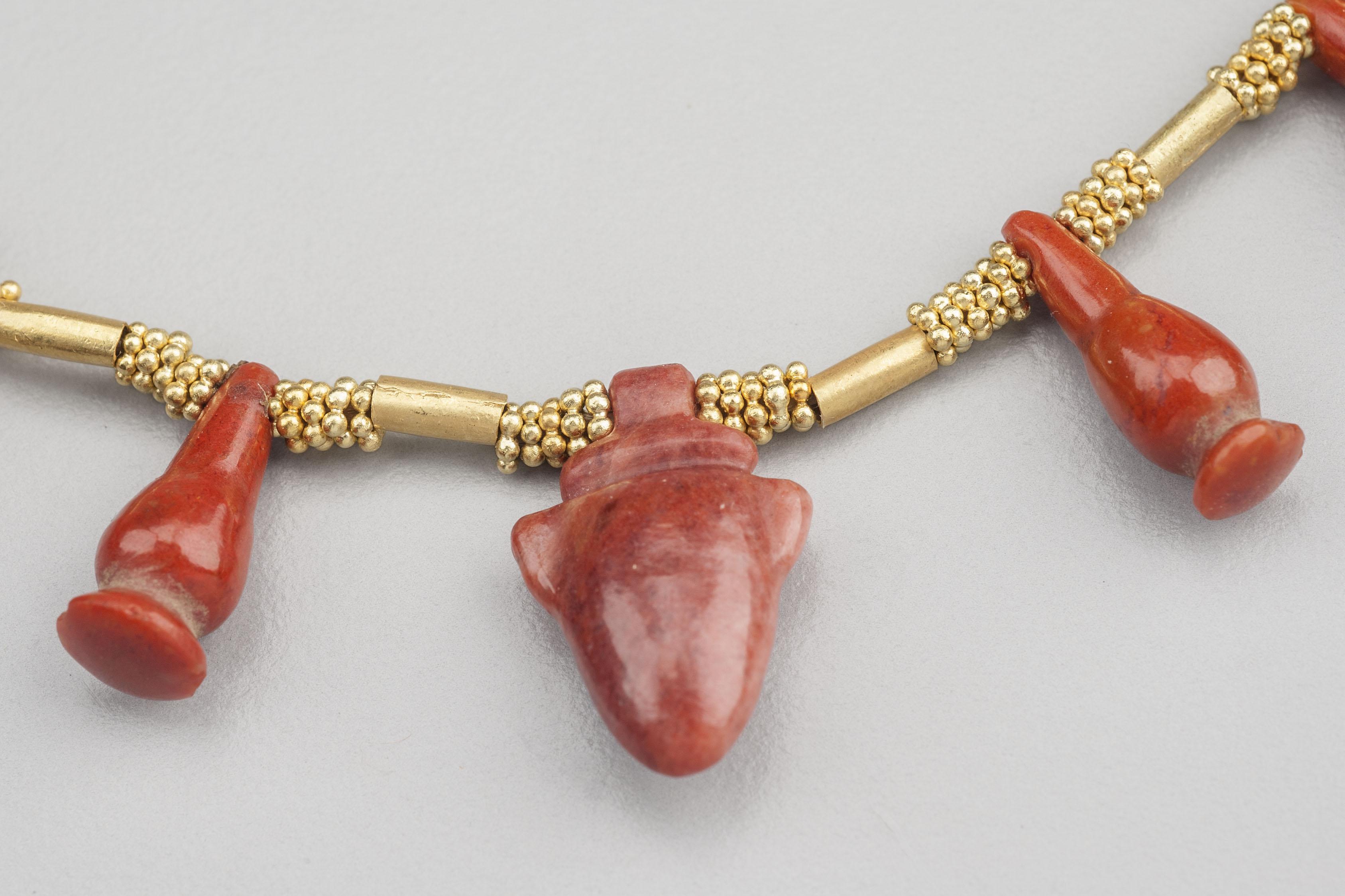 Twelve jasper amulets, three carnelian amulets and two carnelian cylinder beads spaced between 20k gold granulated ring beads and plain gold tube beads. There are thirty-six groups of five rings each between the amulets and the gold tubes. In