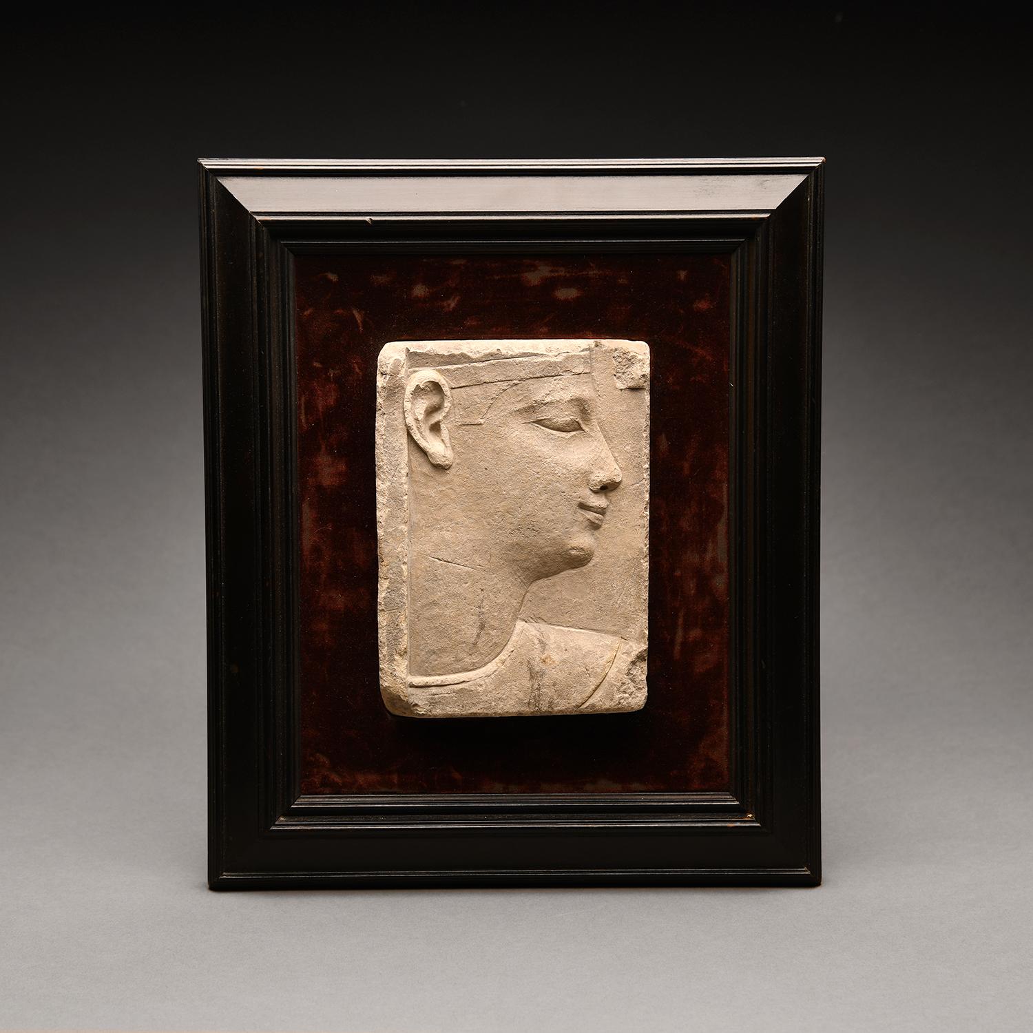 This superb sculptors model is carved in raised relief with the bust of a pharaoh in profile to the right. The noble face features a prominent chin and thick lips. A delicate eye-line and brow lay beneath the headdress head band, which sits just