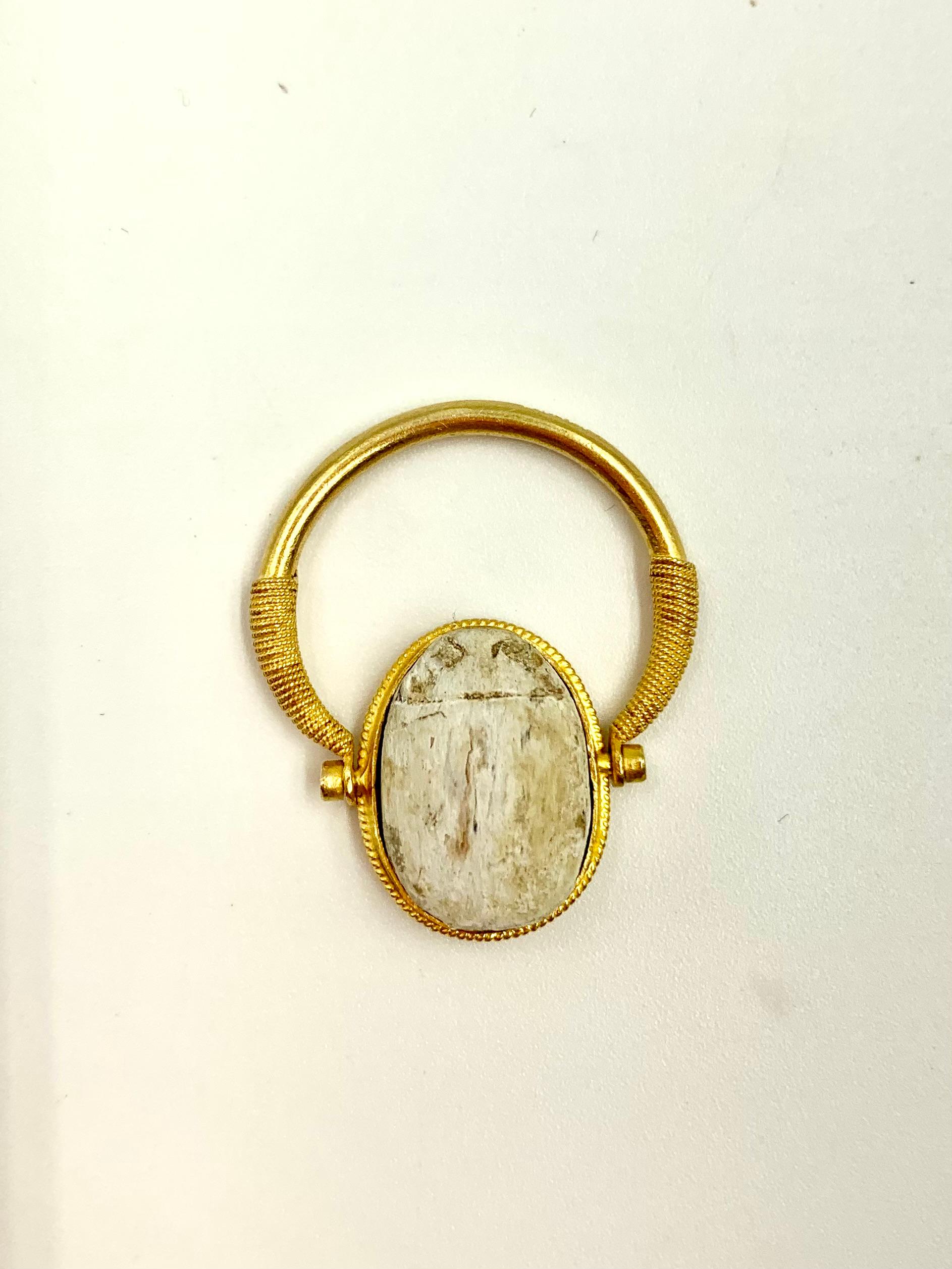 Ancient Egyptian steatite scarab amulet high carat gold swivel signet ring
The Scarab ring design, also called a Scaraboid Seal, was developed as an amulet/signet ring with the scarab symbolizing  immortality, transformation and protection.