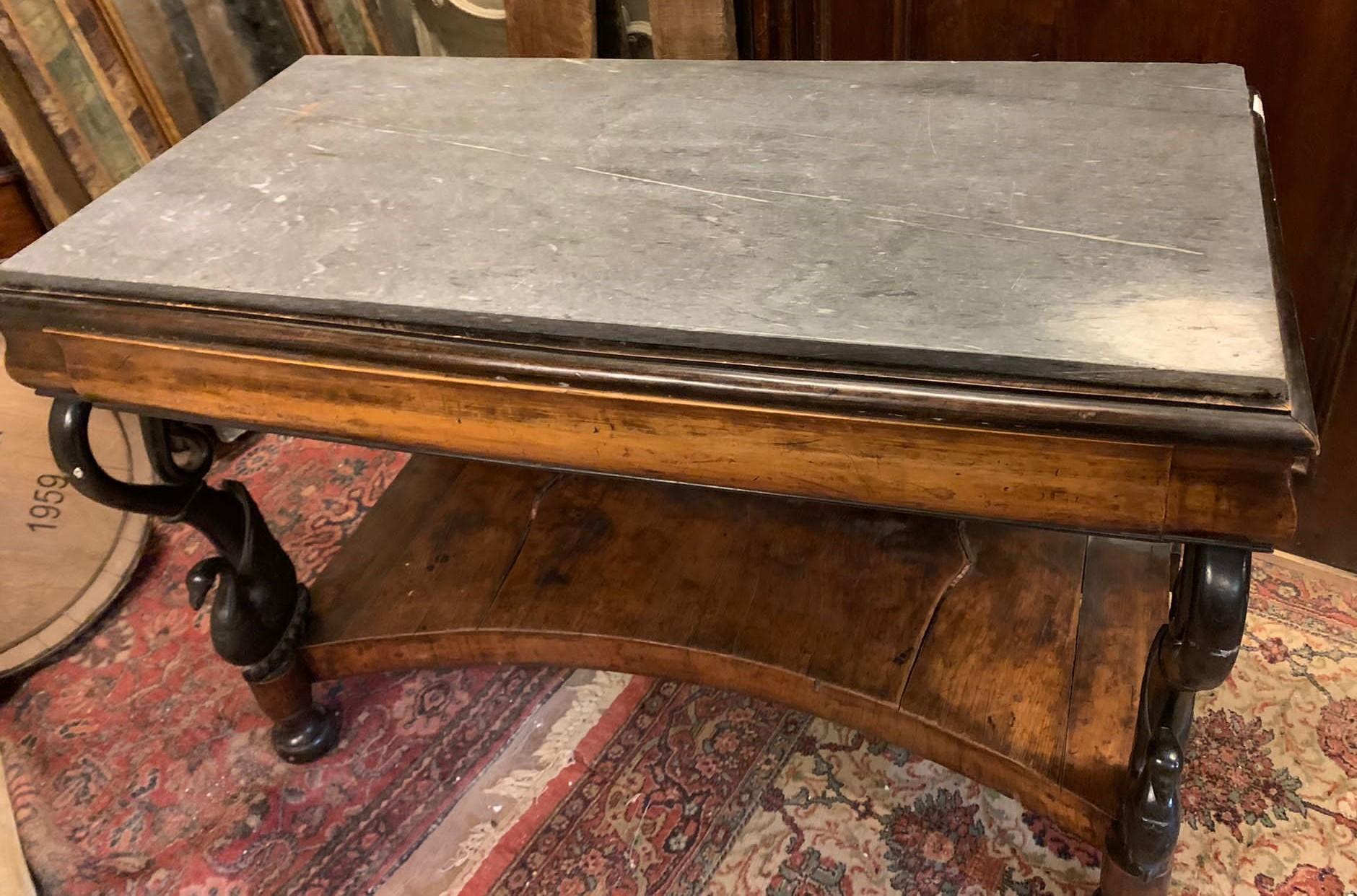 Antique Empire Console table, carved in solid walnut root wood, columns with sculpted and bent black swans, with secret drawer in the pediment and original gray marble top, bent details, hand-built in Italy at the beginning of the 19th century, size