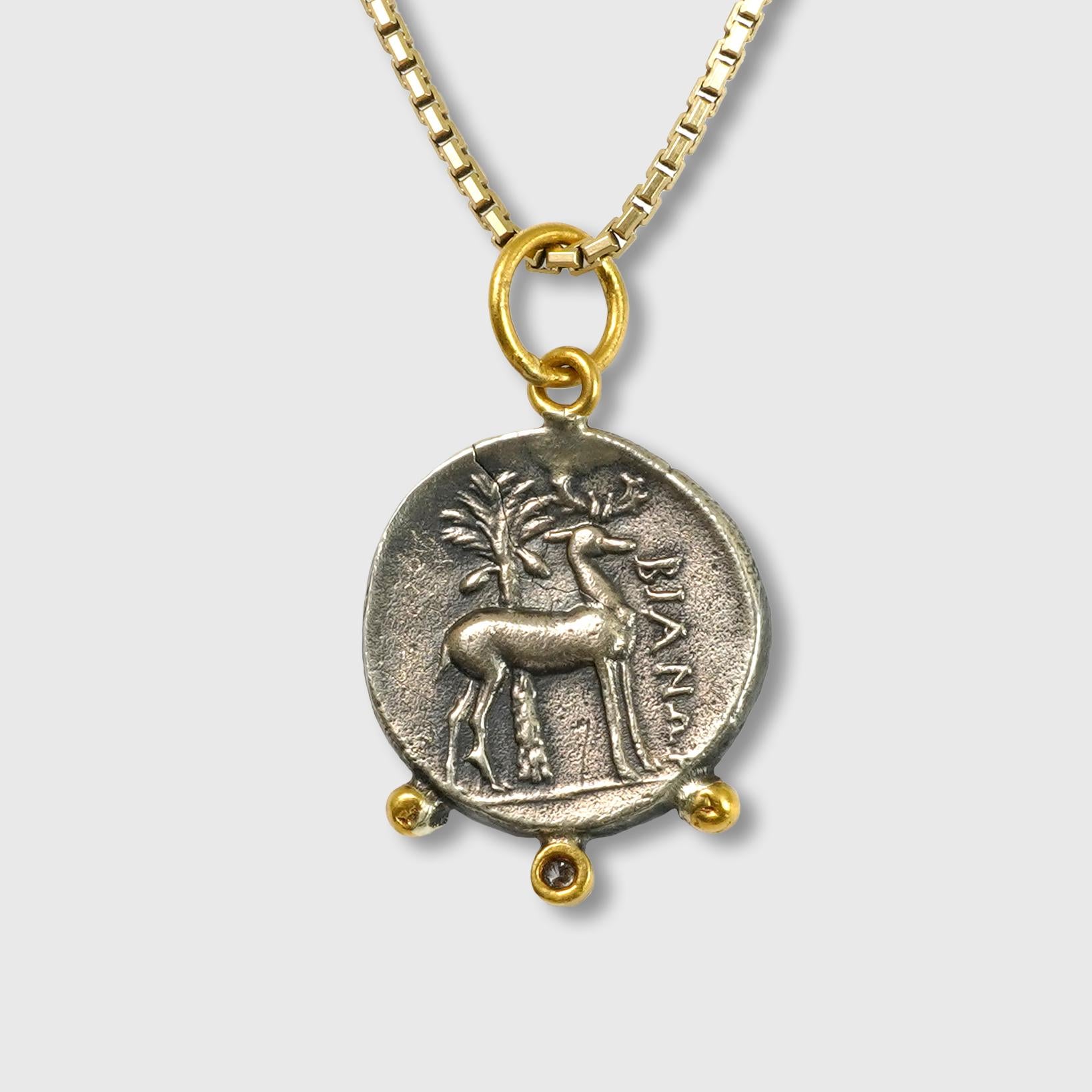 Ephesus, Queen Bee, Tetra Drachm, Charm Pendant, 24kt Yellow Gold, Silver & 0.02ct Diamonds.

Sterling Silver coin is a replica coin from those in the Turkish Museum. 390–380 B.C., Coin (tetradrachm) of Ephesos

3 Diamonds - 0.02cts
24kt Gold-0.65
