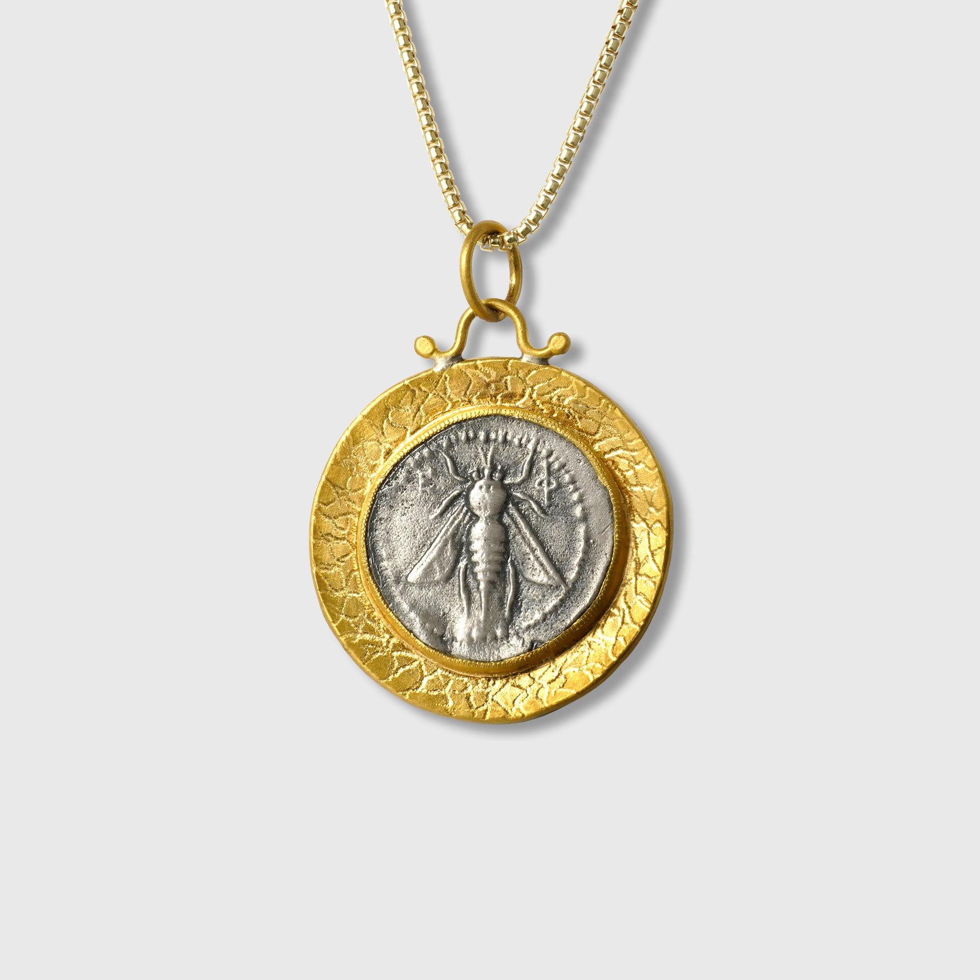 Large, Gold-Framed, Ancient, Ephesus, Queen Bee, Tetra Drachm, Coin (Replica) Charm Pendant, 24kt Gold and Silver

Sterling Silver coin is a replica coin from those in the Turkish Museum. 390–380 B.C., Coin (tetradrachm) of Ephesos

24kt Gold-1.92