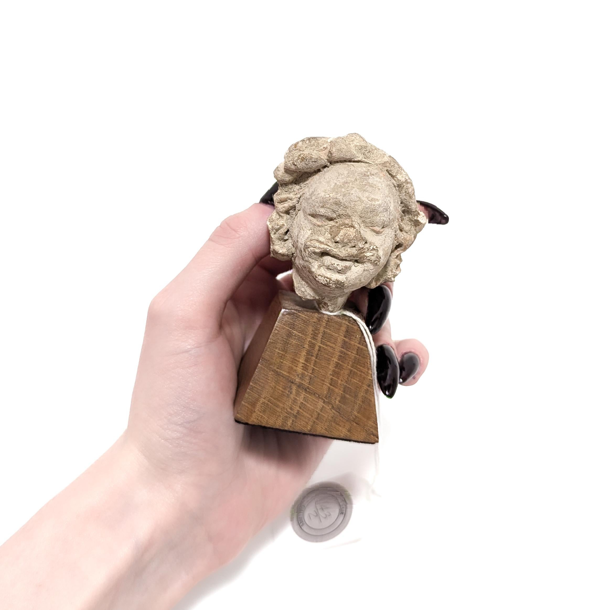 A fine ancient stucco bust on a plinth.

In the form of the mustachioed man with a (partial) laurel on his head.

Mounted on a brown wooden plinth.

Retaining an old Stair Galleries auction label.

Simply a wonderful ancient miniature bust!

Date: