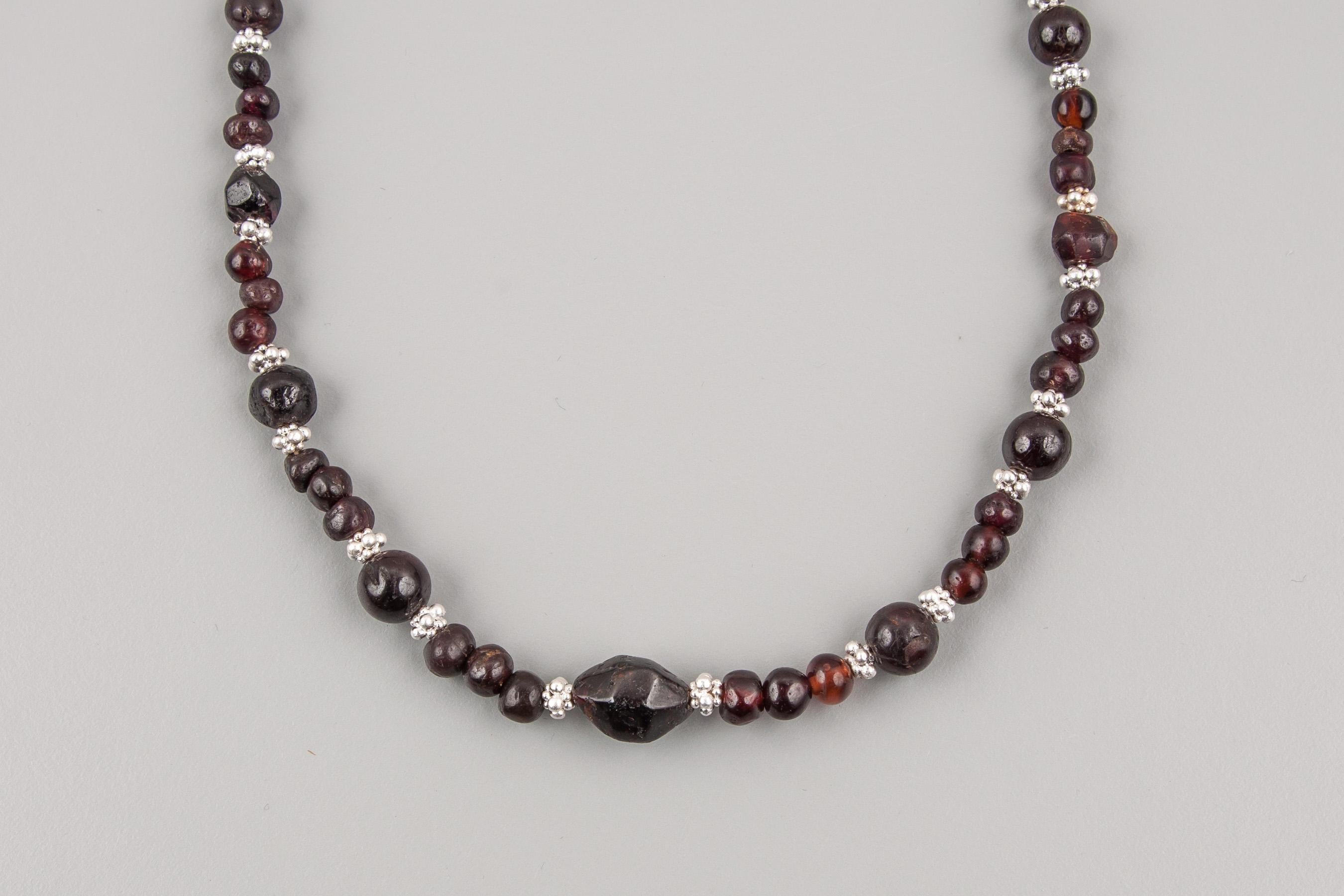 Ancient garnet beads paired with handmade fine silver 